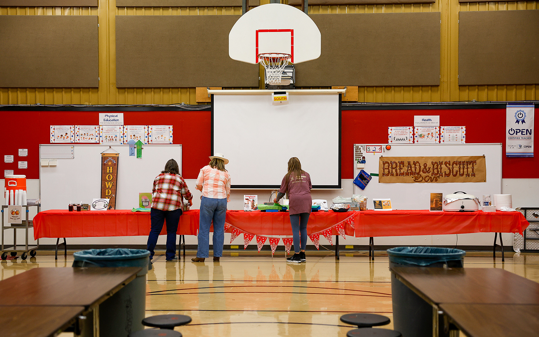 From left, Lindsey Mueller, Suzanne Jackson and Melissa Moore prepare for the hootenanny on March 19 at Two Mile Prairie Elementary School. Mueller teaches third grade, Jackson teaches second-grade and Moore works for Two Mile Prairie as a custodian.