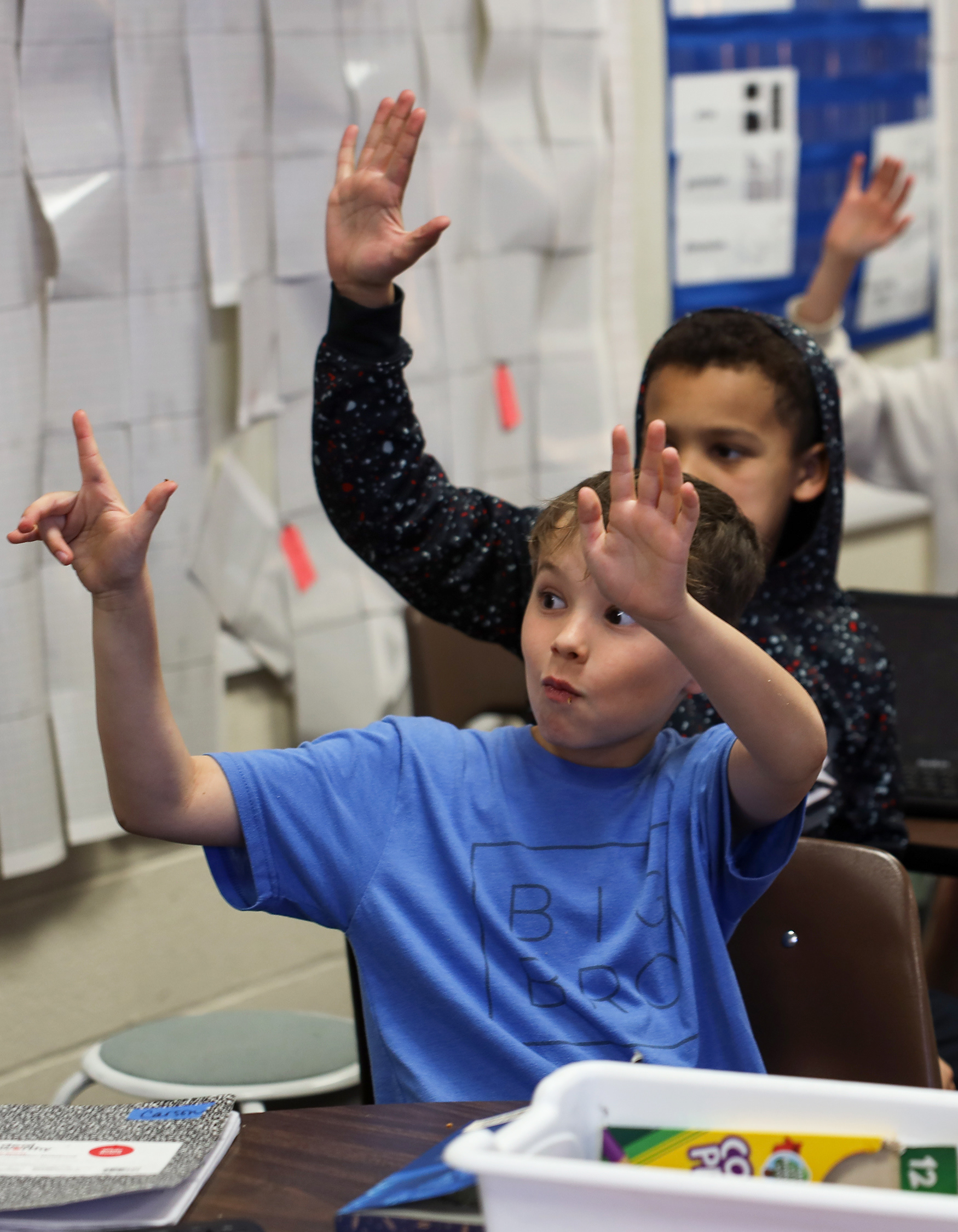 Shane Richard, 10, front, and Bryton Bradley, 9, score their homemade biscuits and gravy on March 19 at Two Mile Prairie Elementary School. Students cooked a variety of foods including biscuits and gravy, whipped cream and cinnamon, and strawberry frosting. 