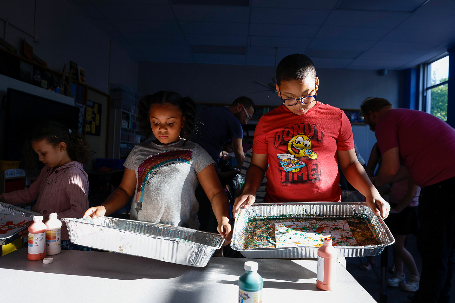 From left, Benton first grader Kalani Reynolds, 7, and her brother, Benton fifth grader Kindrick Reynolds, 10,  make marble paintings at a STEAM night event on May 7 at Benton STEM Elementary School in Columbia. Kalani, Kindrick and their mother always attend the STEAM night events to support the community.
