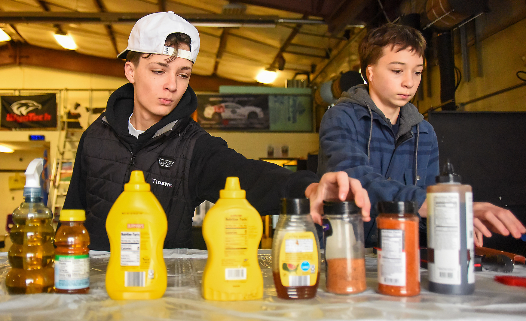 Hallsville Middle School eighth graders Braden Heet, left, and Chase Melloway, right, organize their sauces before starting their smokers on March 2 at Hallsville High School. This is the first year that Hallsville Middle School has participated in FFA.