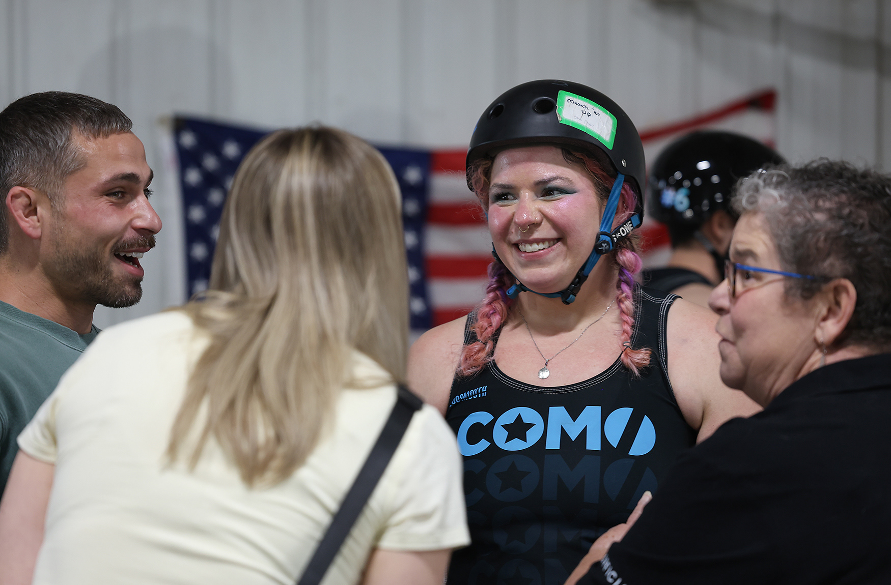 Kelsey Mescher smiles in conversation with with her mother Kelly Mescher (right), Josh Gaskins (left) and his partner Kelly Gaskins (center left) after CoMo All Stars’ 229-121 win against Tulsa Elite on April 11 at the Bob Lemone Building in Hallsville.