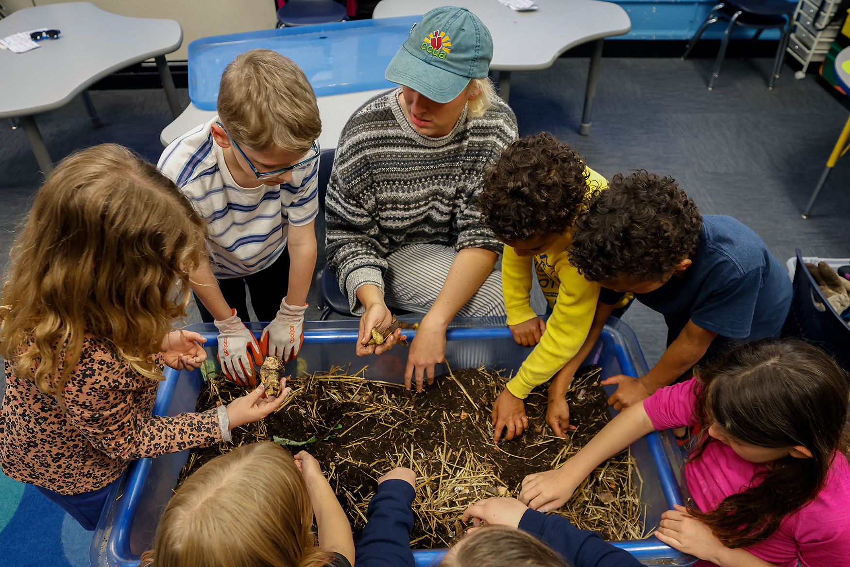 Amity Freiman, a farm to school educator with Columbia Center for Urban Agriculture, leads an interactive activity with a compost exploration table at a STEAM night event on May 7 at Benton STEM Elementary School in Columbia. “We like to be involved in our local school,” said Philip Long, father of Benton third grader Evie Long, 7. “She loves science-y stuff and getting her hands dirty.”