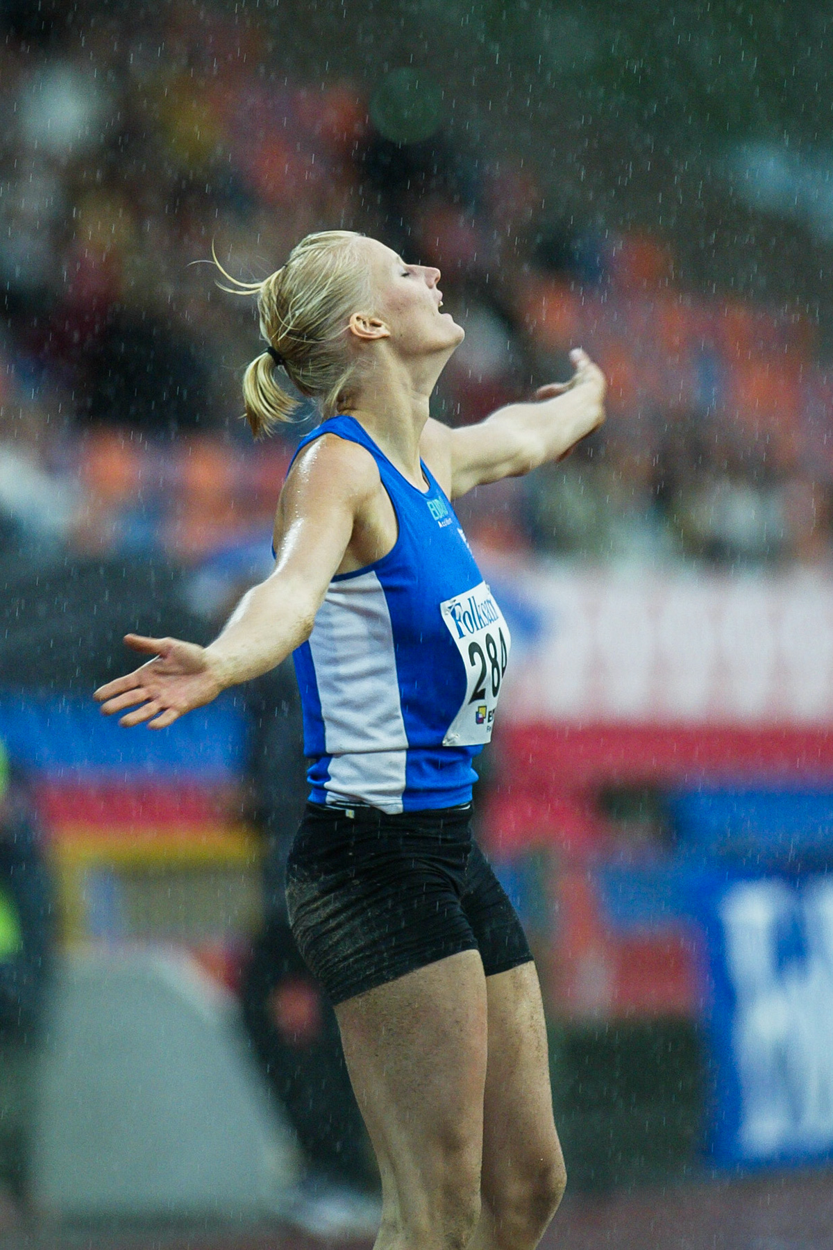 Carolina Klüft celebrating in the rain after the long jump in Växjö 2004