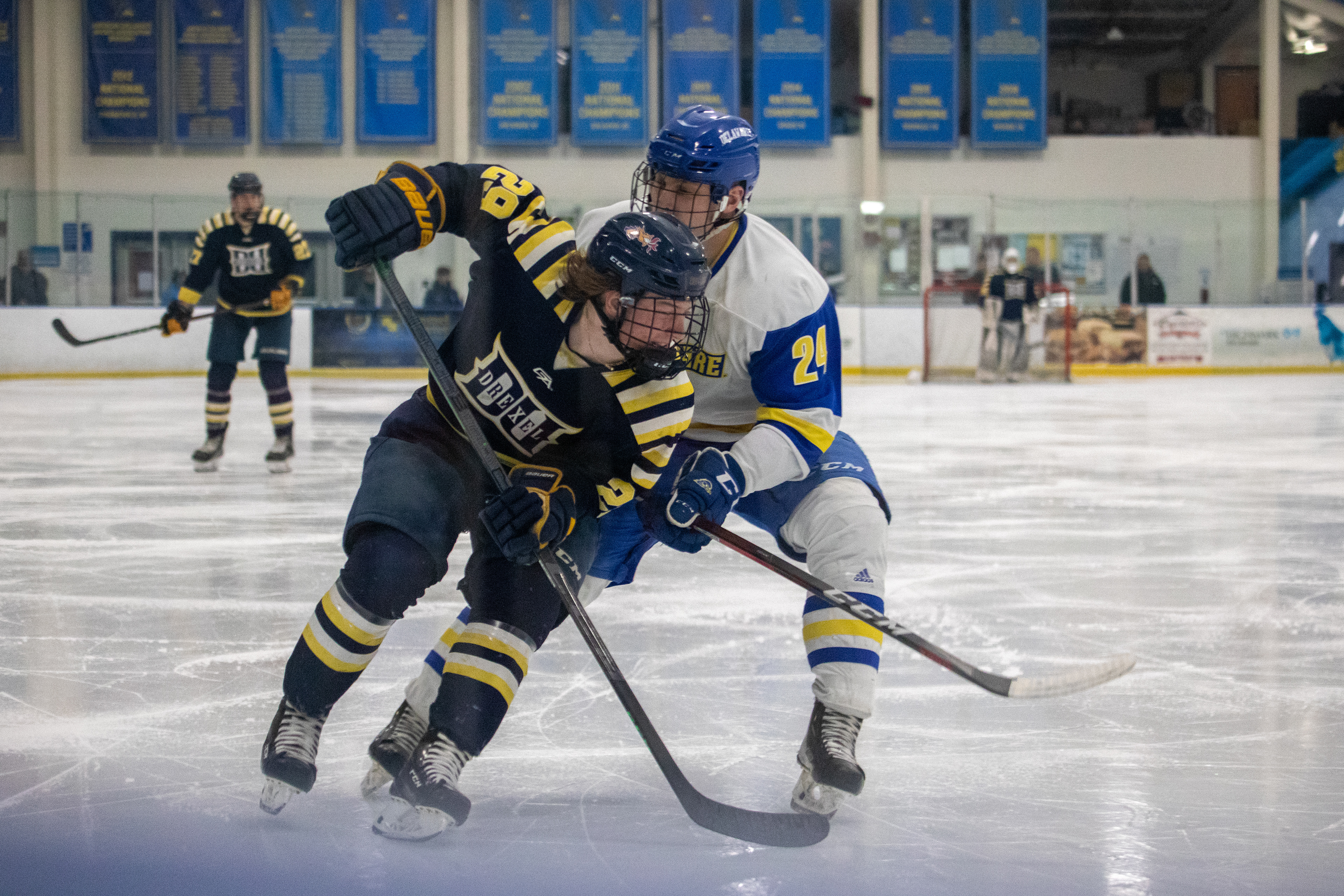 Drexel D1 Forward #29 Ryan Sambuco makes a play on the boards with a University of Delaware Defenseman on his back on 01/27/2023.