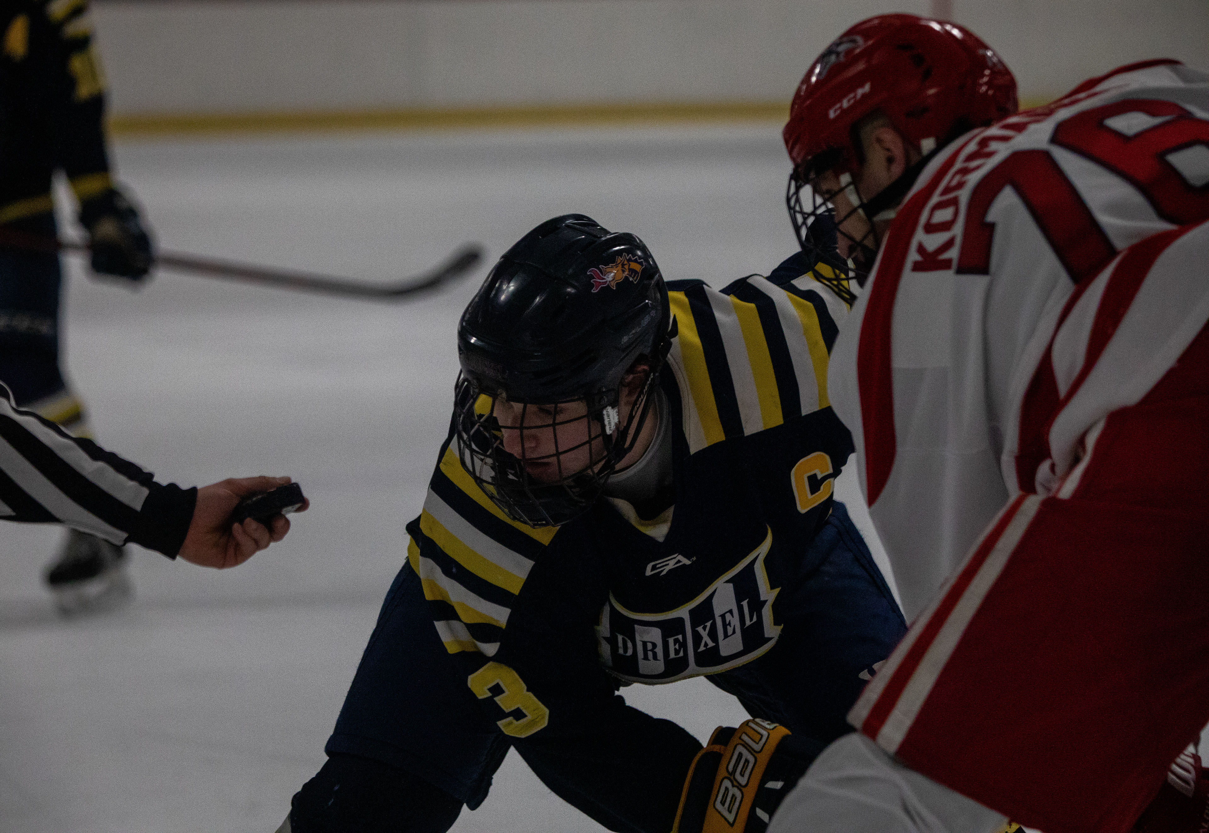 Drexel D1 Captain and Forward #13 Pat McGinley preparing to take a faceoff against Stony Brook University on 02/04/2023.