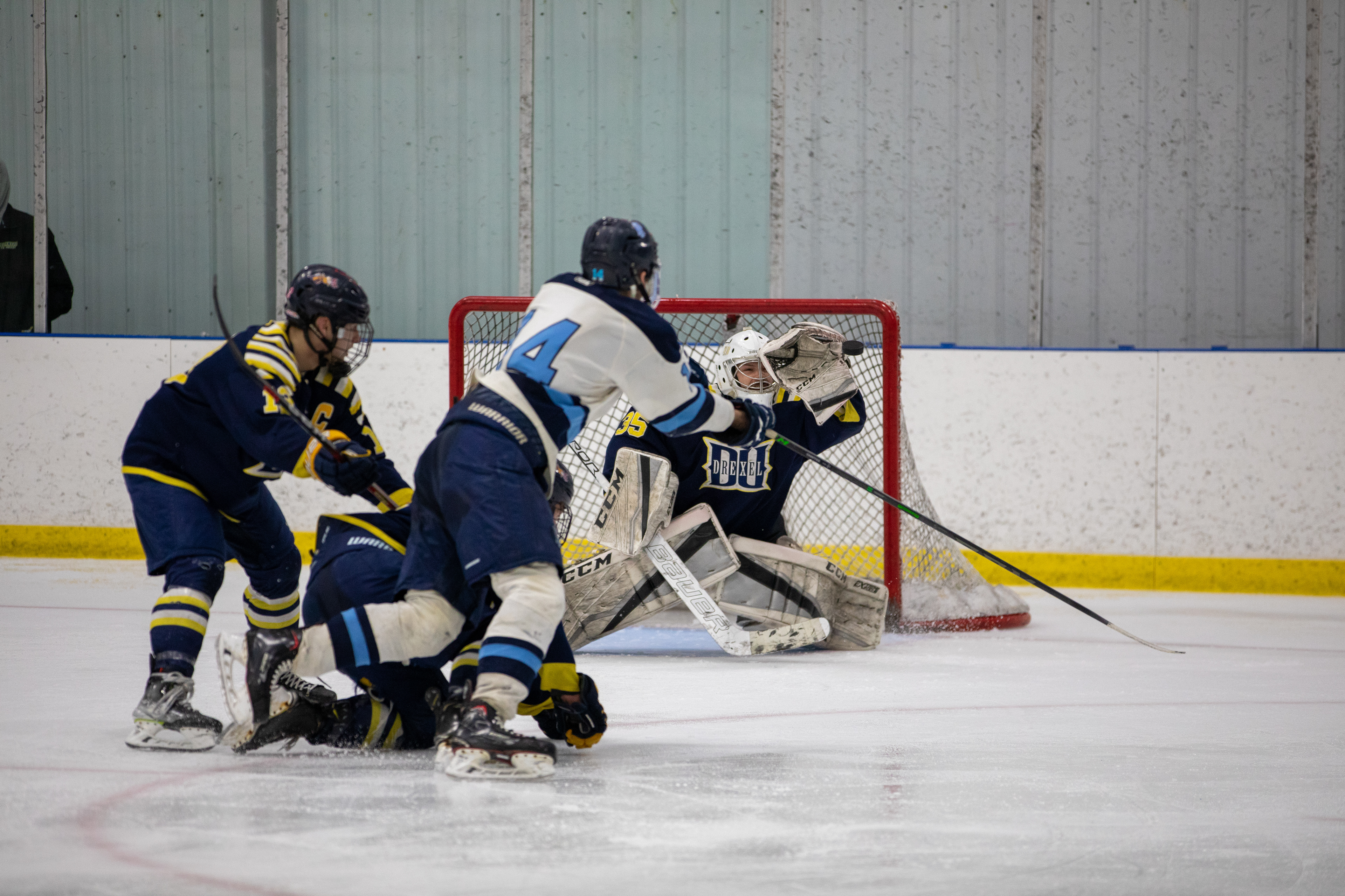 Drexel D1 Goalie #35 Logan Kramsky makes a glove save against the University of Rhode Island on 03/04/2023.