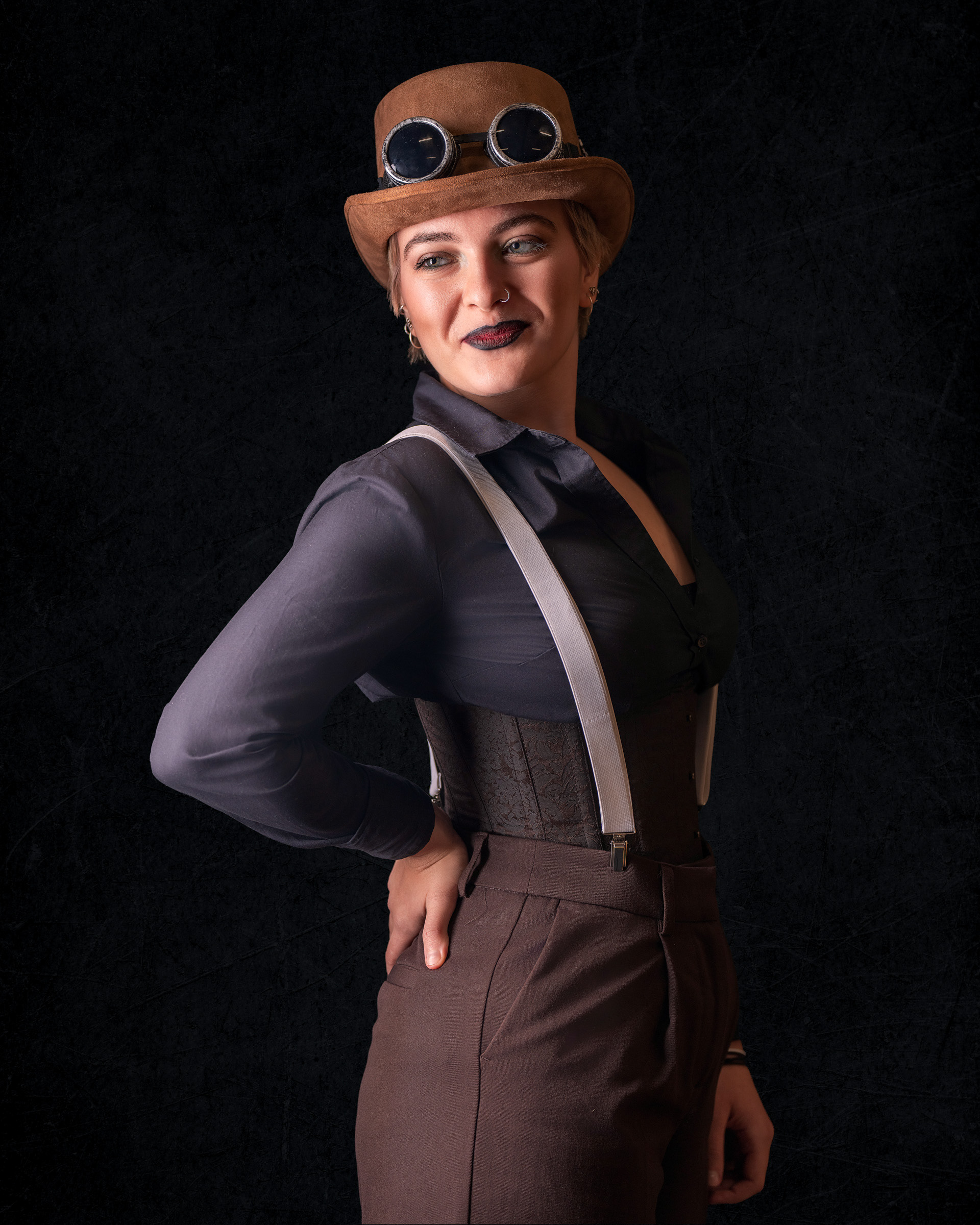 Character-inspired studio portrait of Tirza in steampunk outfit with dramatic lighting