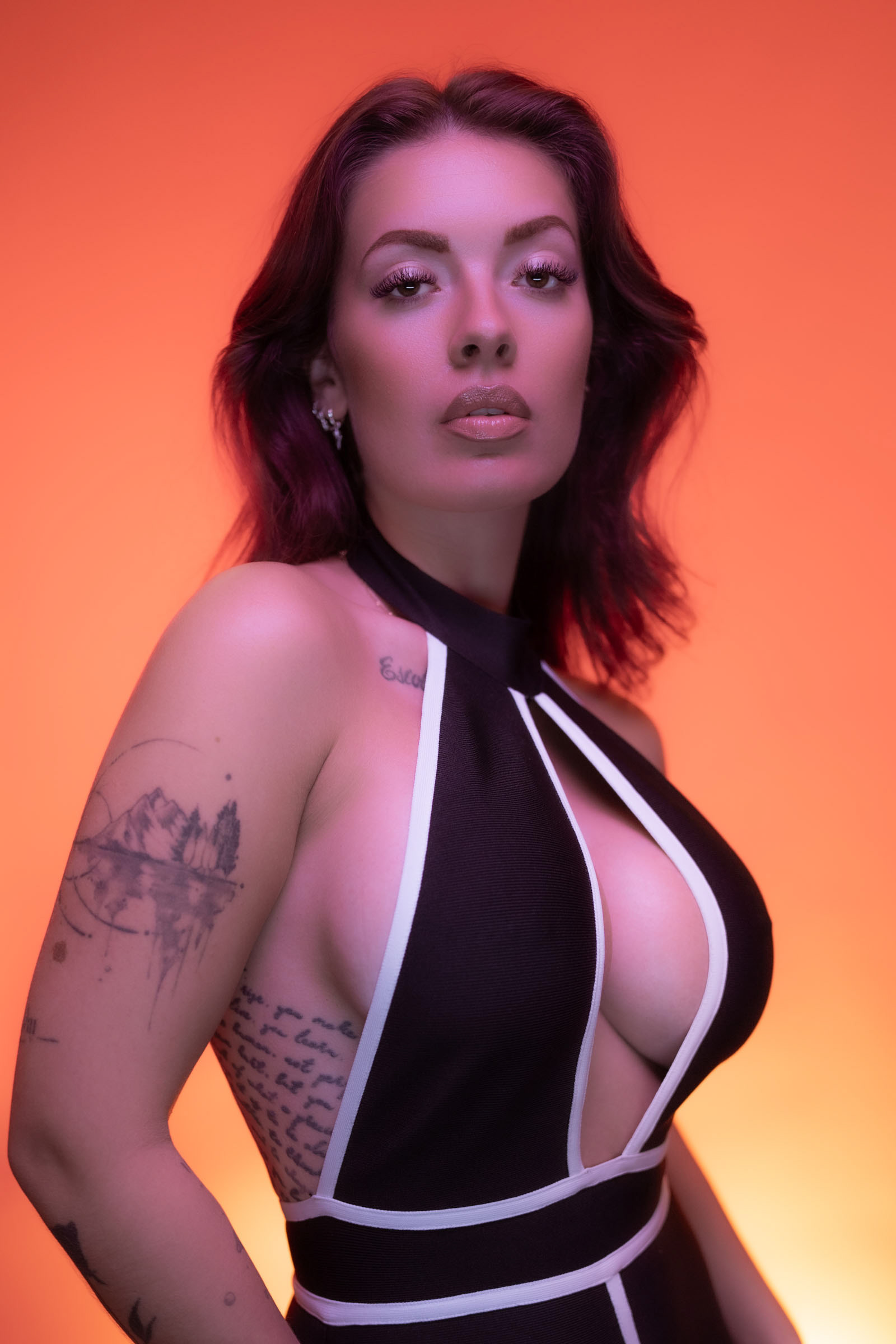 Editorial-style portrait with strong pose and warm orange lighting, captured at a Goecker and Sony fashion photography event.