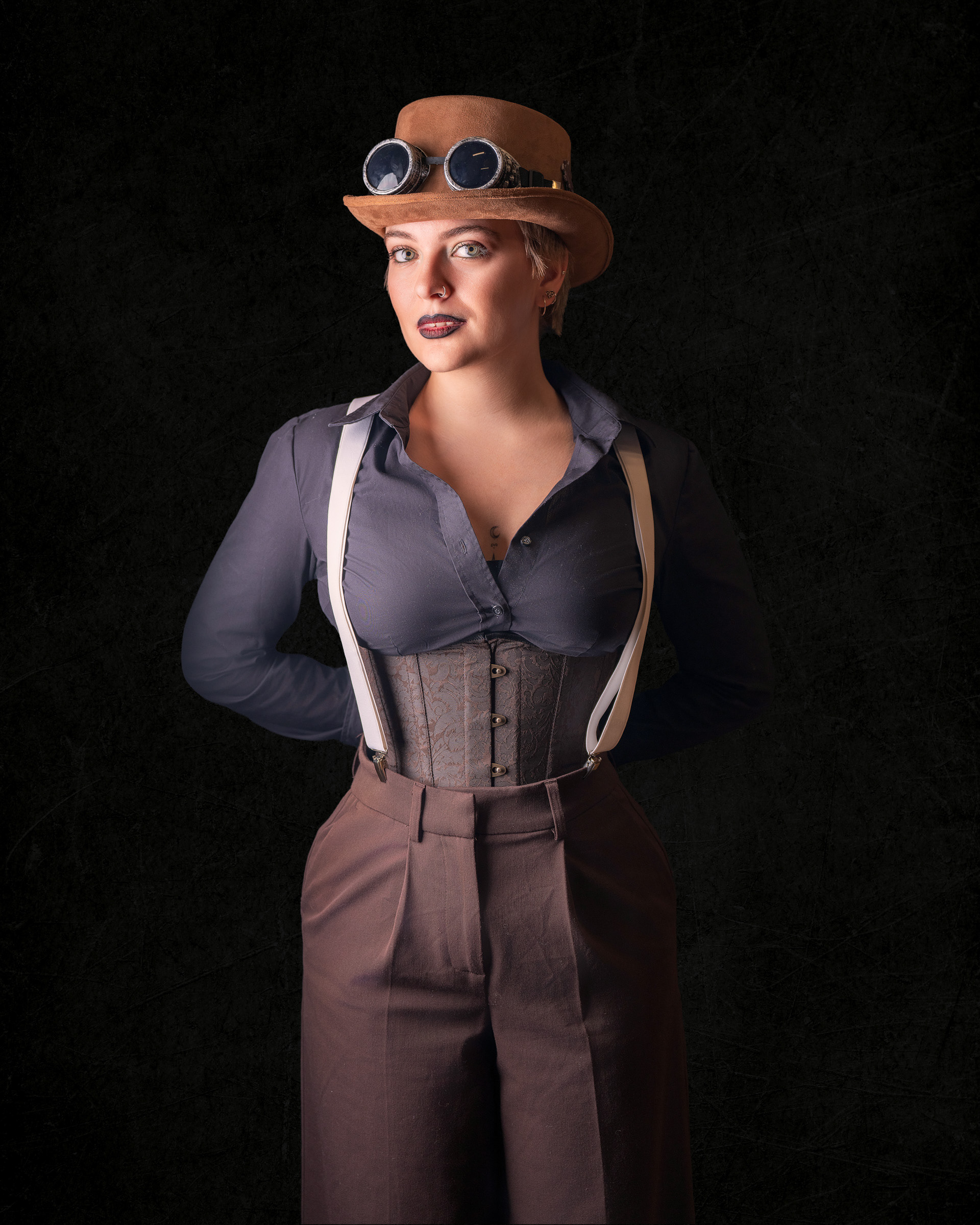 Professional cosplay studio portrait of Tirza in steampunk costume with dark background