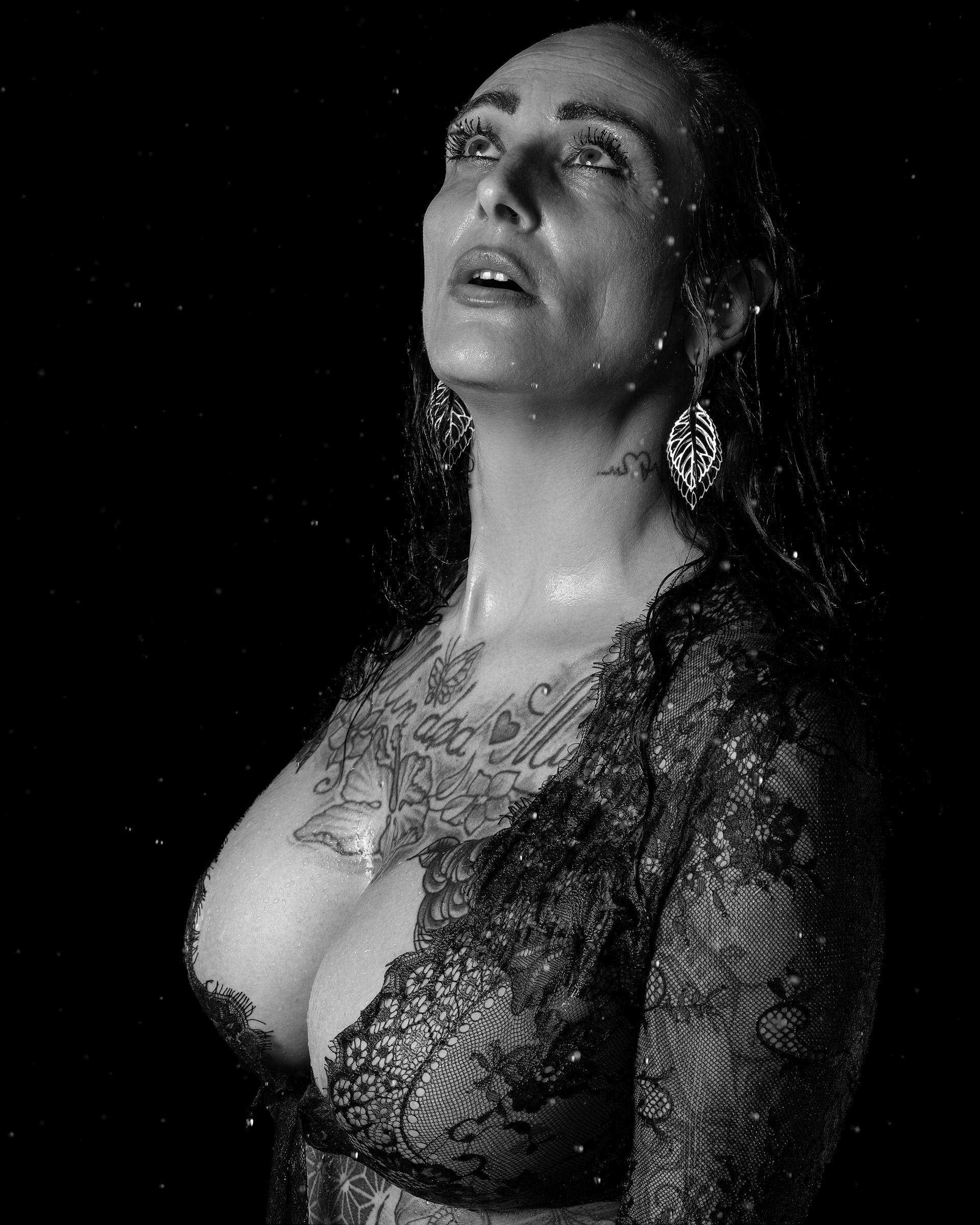 Cinematic rain portrait of Terese in lace lingerie captured in black and white studio setting