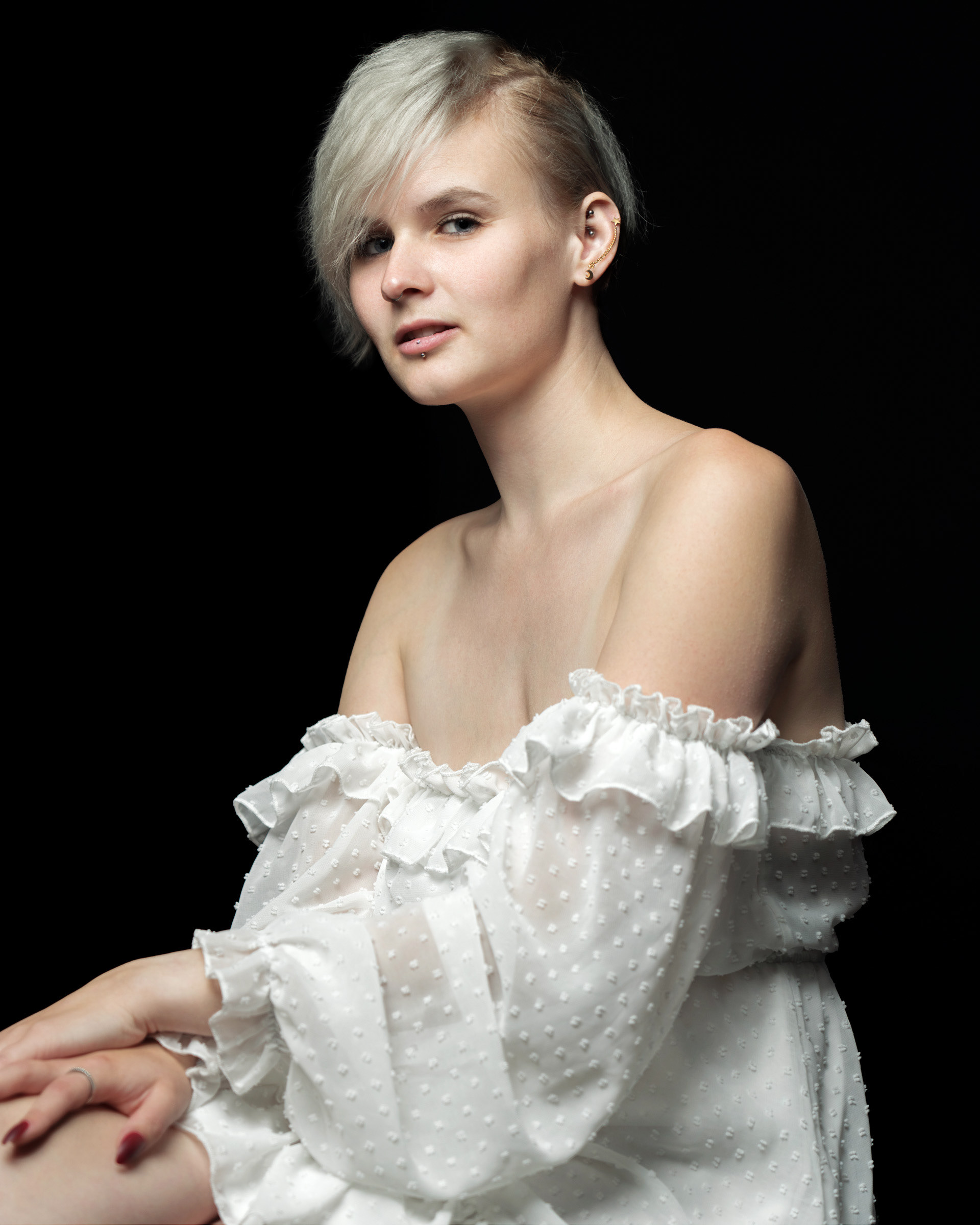 Soft light studio portrait of Sisse wearing white dress with natural expression