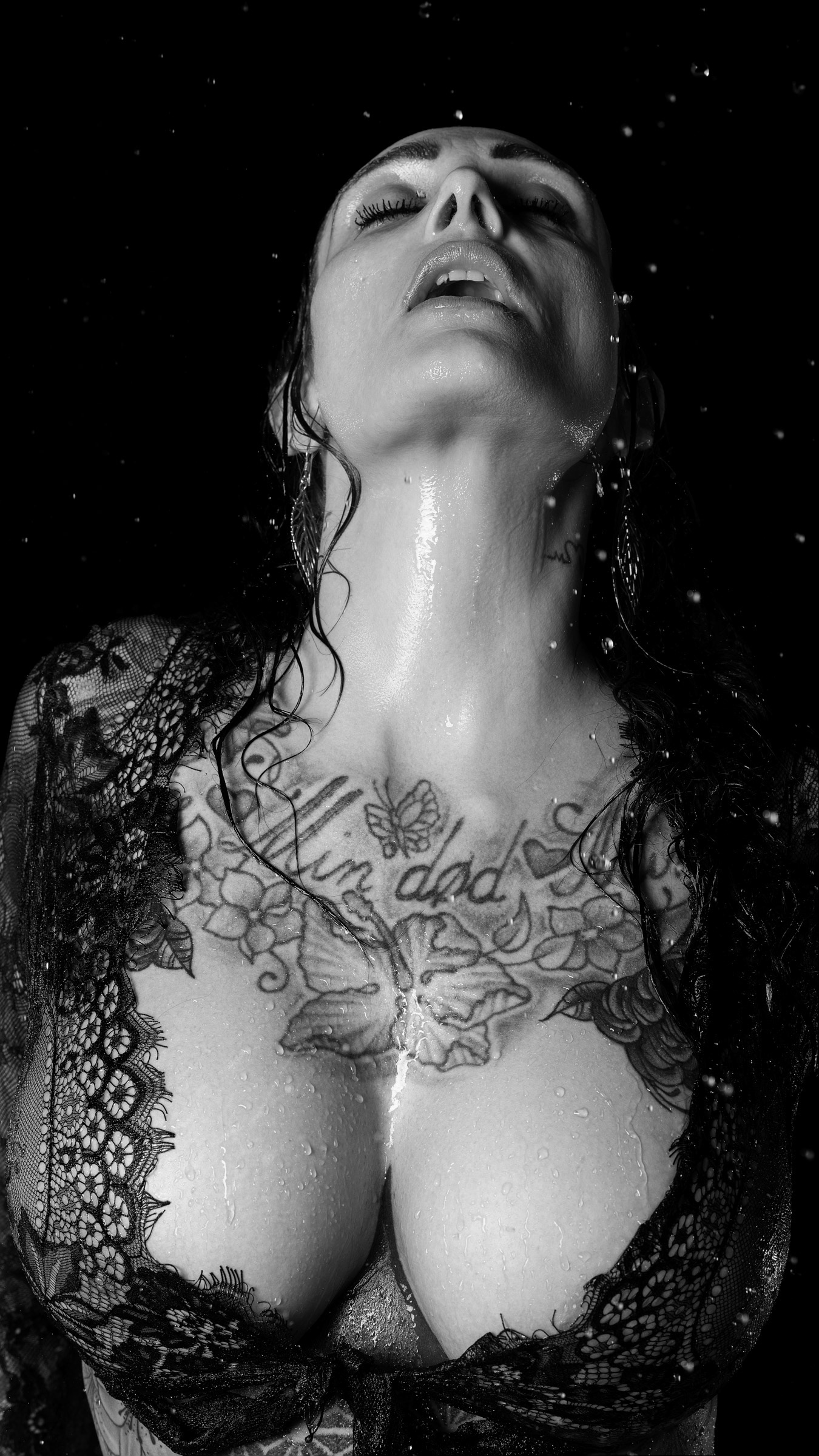Intense black and white close-up portrait of Terese in wet studio photoshoot with artistic lighting