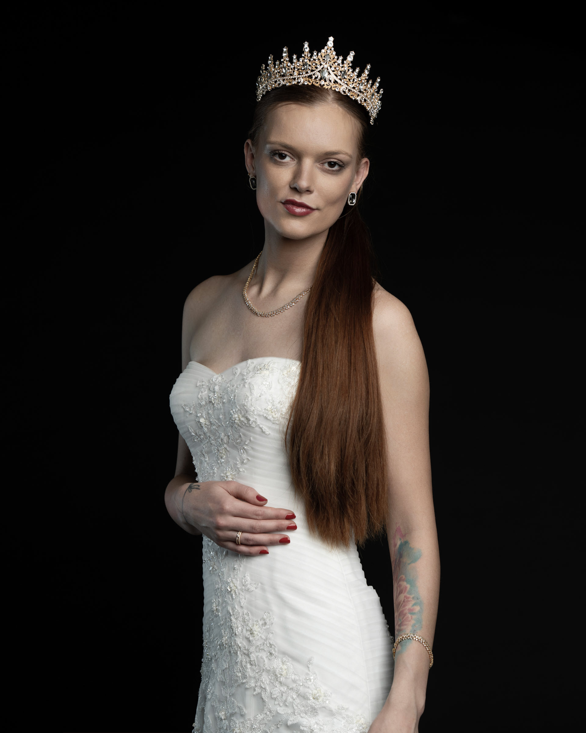 Front-facing portrait of Noamynte in a detailed wedding gown, wearing a crown and minimal jewelry.