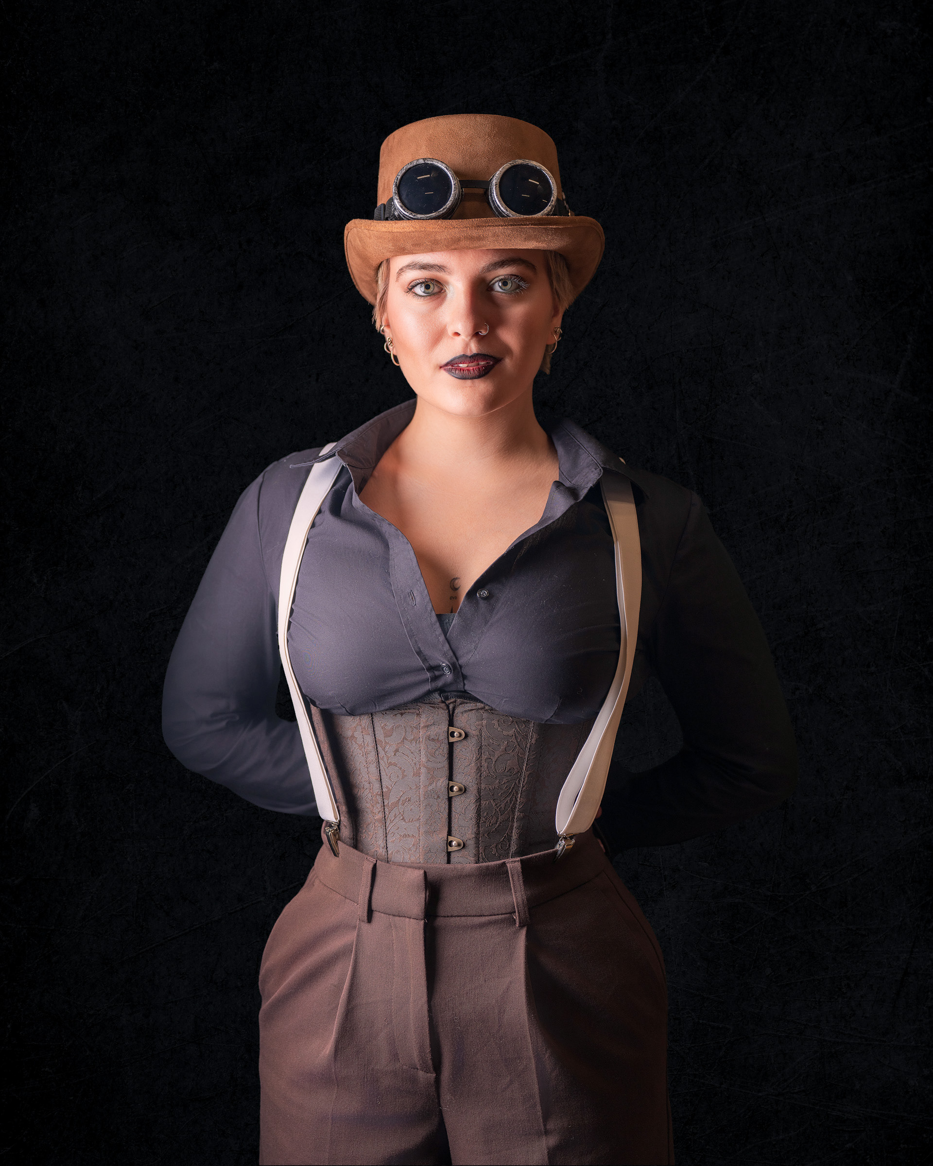 Creative studio photoshoot of Tirza in steampunk cosplay with confident character pose