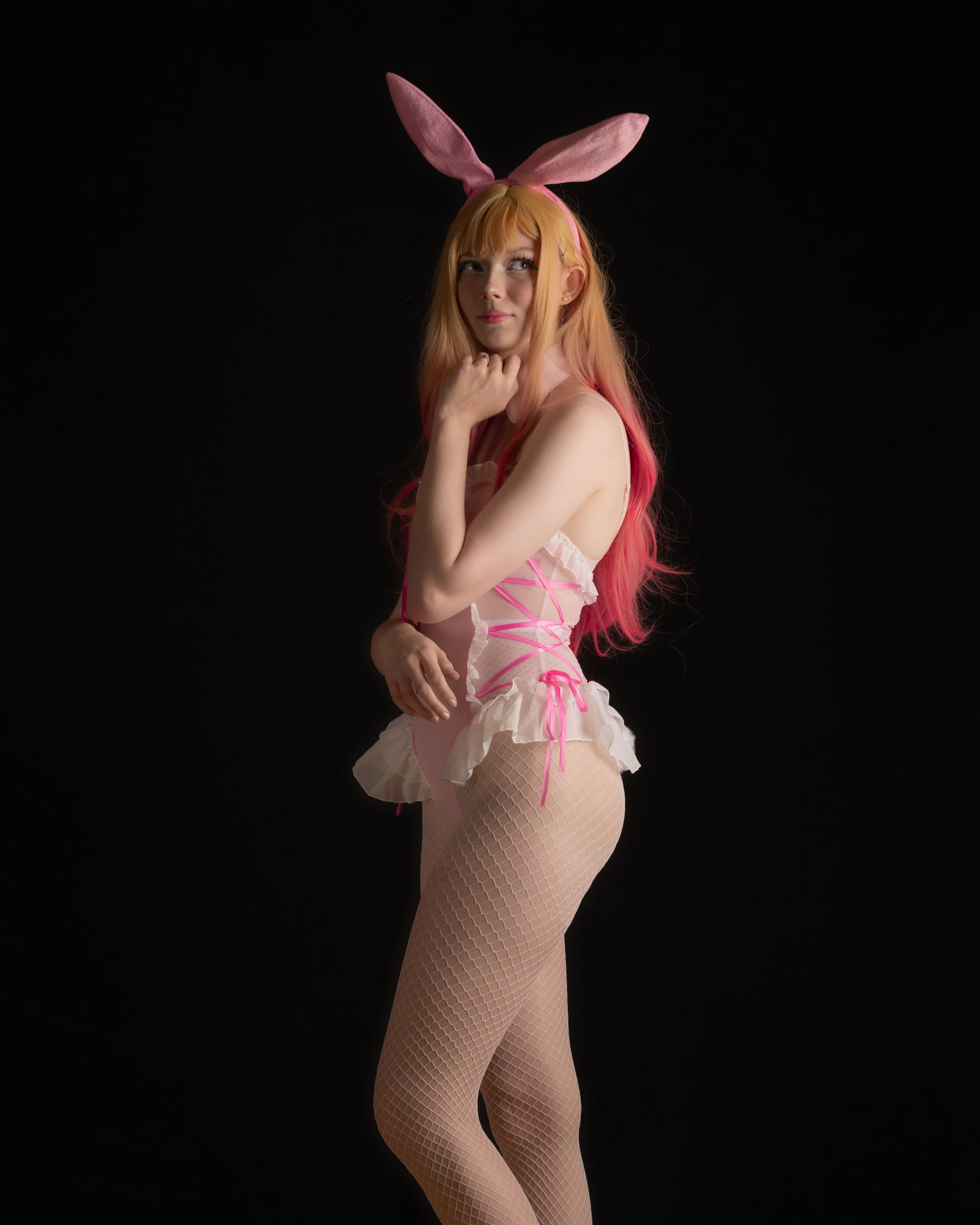 Pastel bunny cosplay with Ninu, standing pose with gentle lighting and cute, flirty mood.