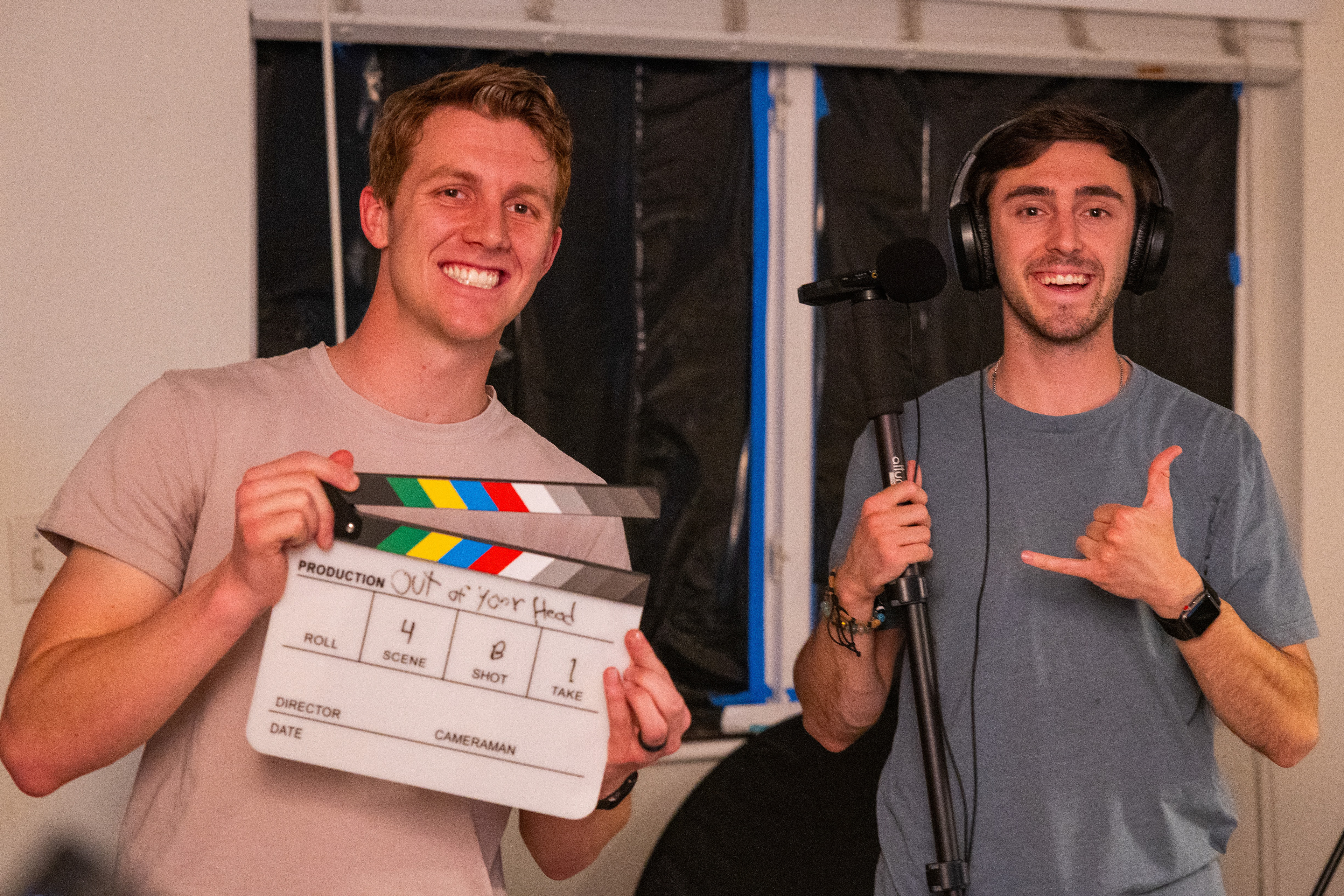 On set with the clapper while directing a Short Film