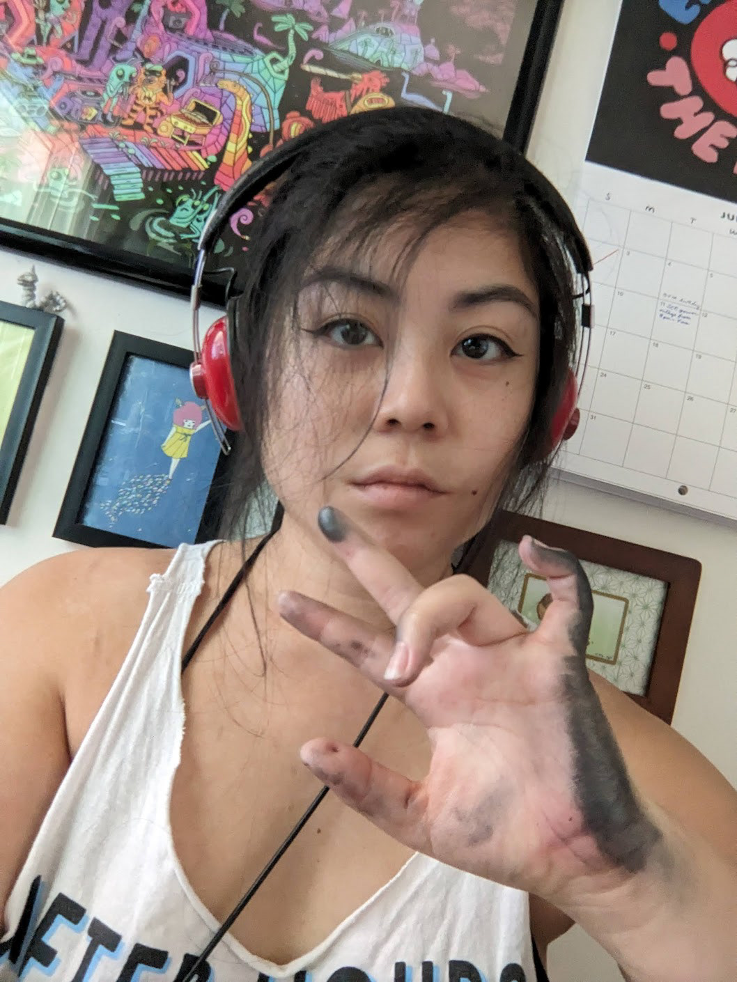 kelly yamagishi wearing red headphones with graphite on her hand