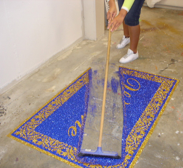 Glitter carpet welcome mat being swept up