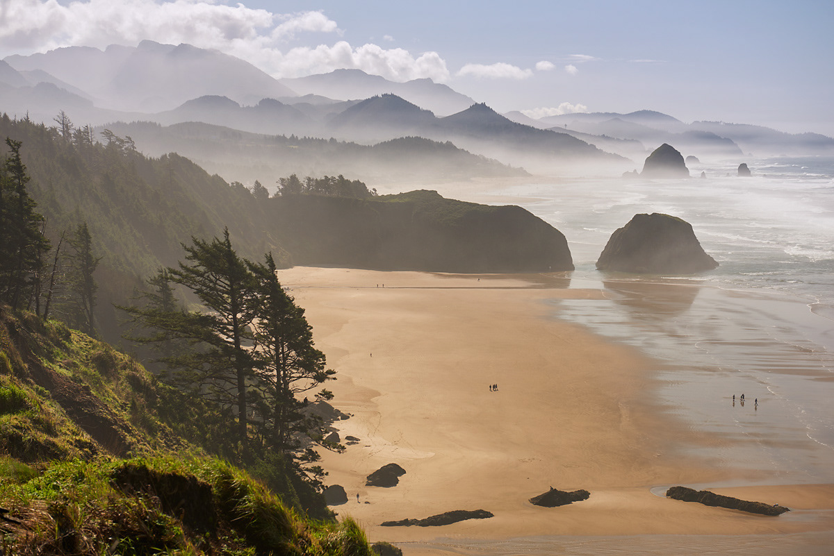 Giant beaches with sea stacks and mist in Oregon coastline photo.