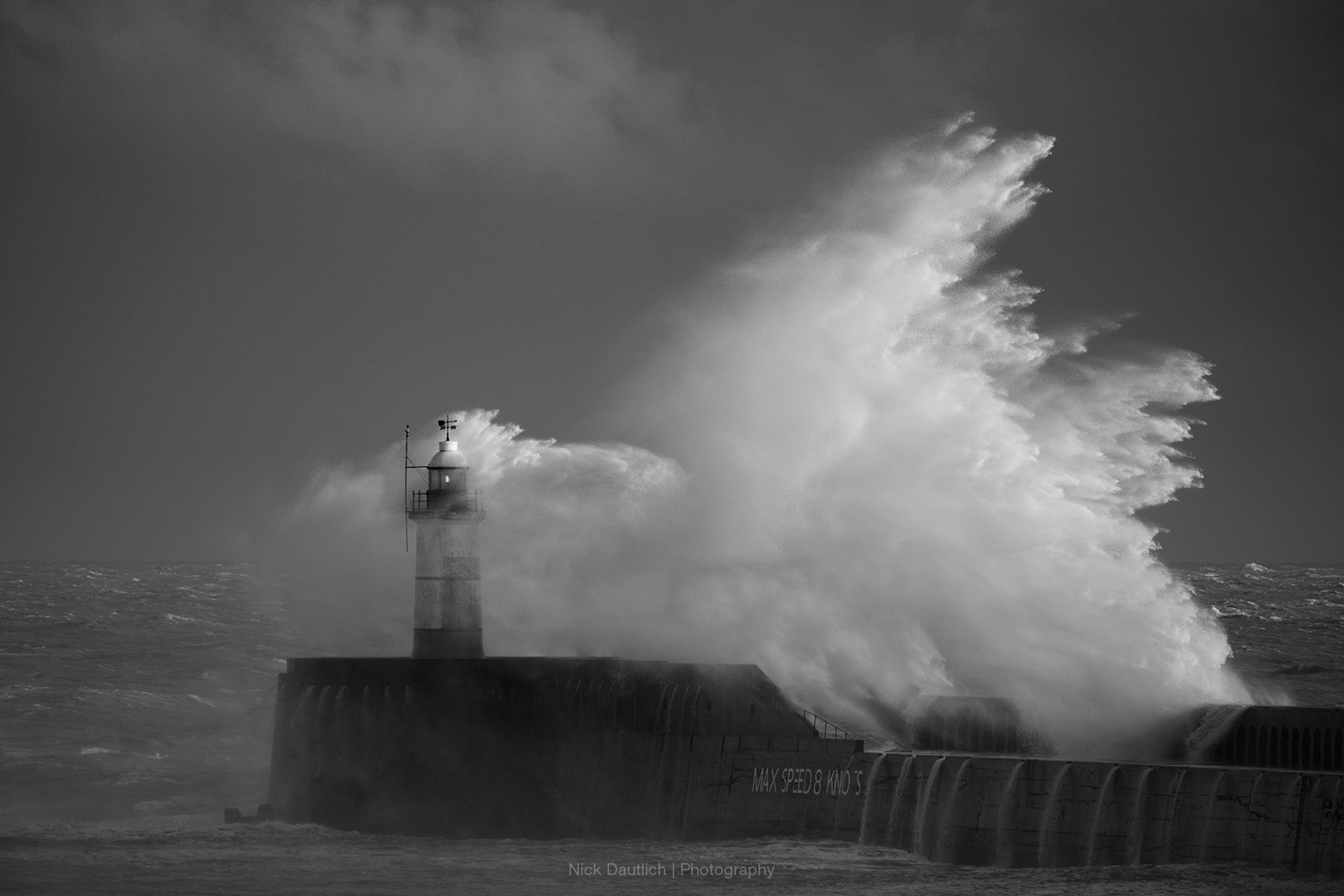 Waves on the Sussex coast striking lighthouse