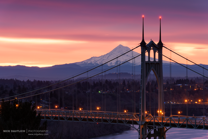 Mount Hood behind St Johns Bridge in Portland with glowing sunrise colours