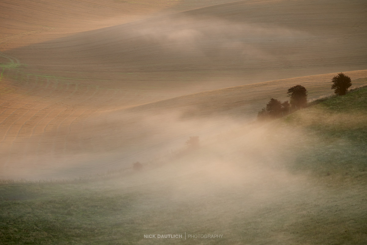 Mist over rural hills in Sussex landscape
