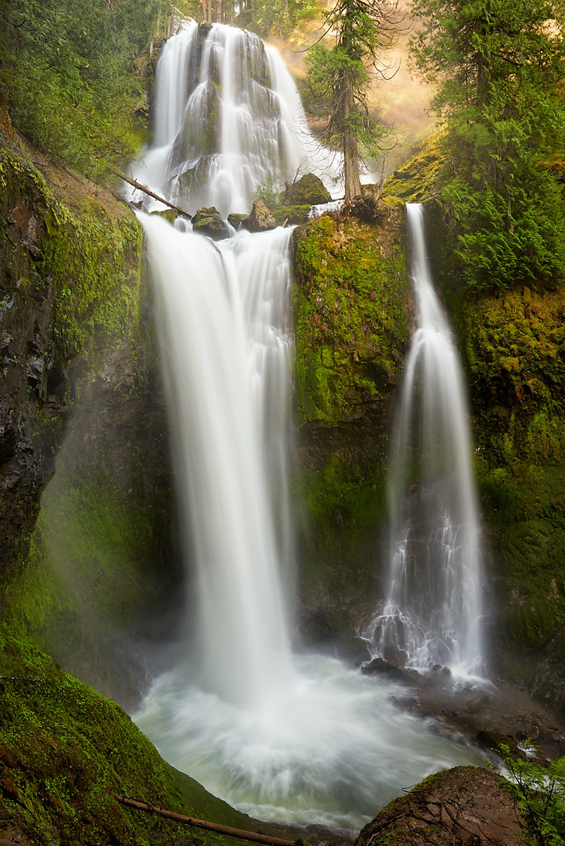 Raw power of multi tiered waterfall crashing down mountainside