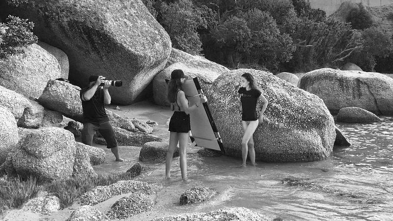 Photographer LeFu shooting on a beach in Cape Town. Behind the scenes of an on-location fashion shoot.