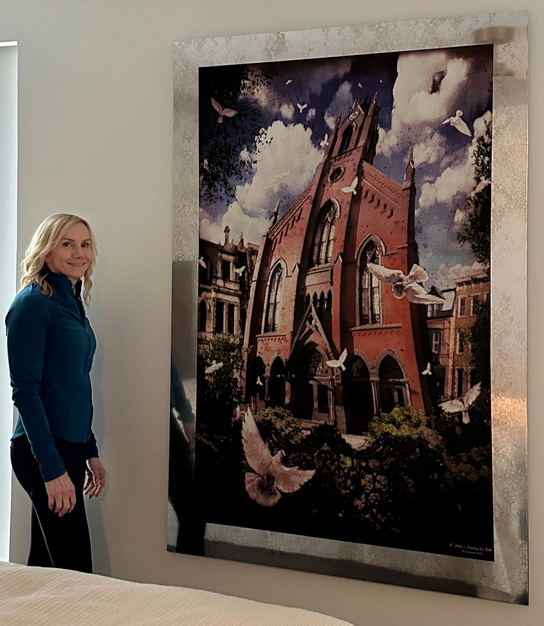 Carol beside a 6 x 4' print of "St. John's Sunday Six Bells (OTR) " after hanging it in an apartment near Lytle Park, Cincinnati.