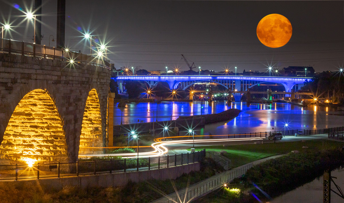Commercial cityscape photography of the Minneapolis Stone Arch Bridge and Mississippi River by John Hermansen