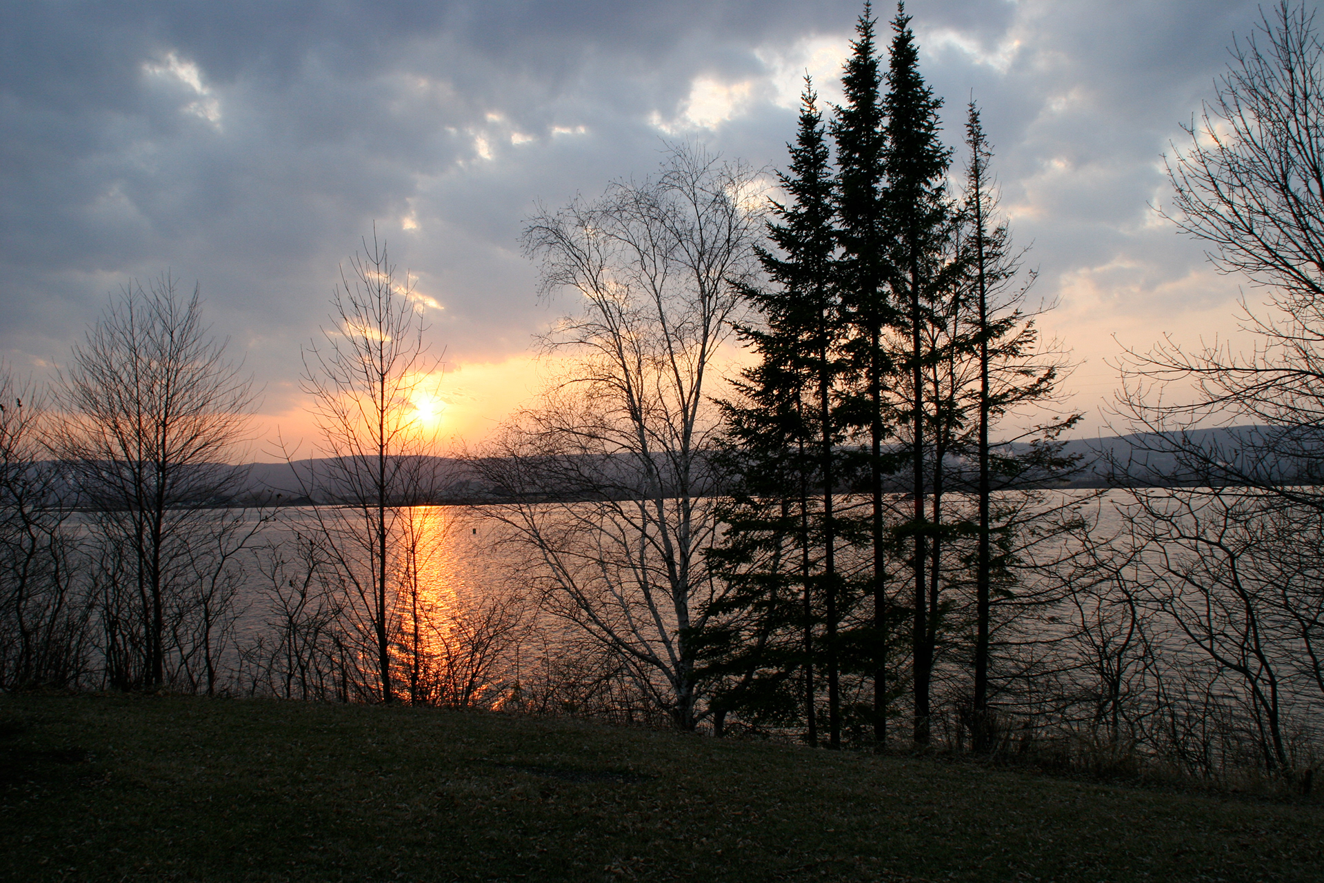 Dramatic Vibrant Sunset Reflecting Over Calm Northern Minnesota Lake Water Surface