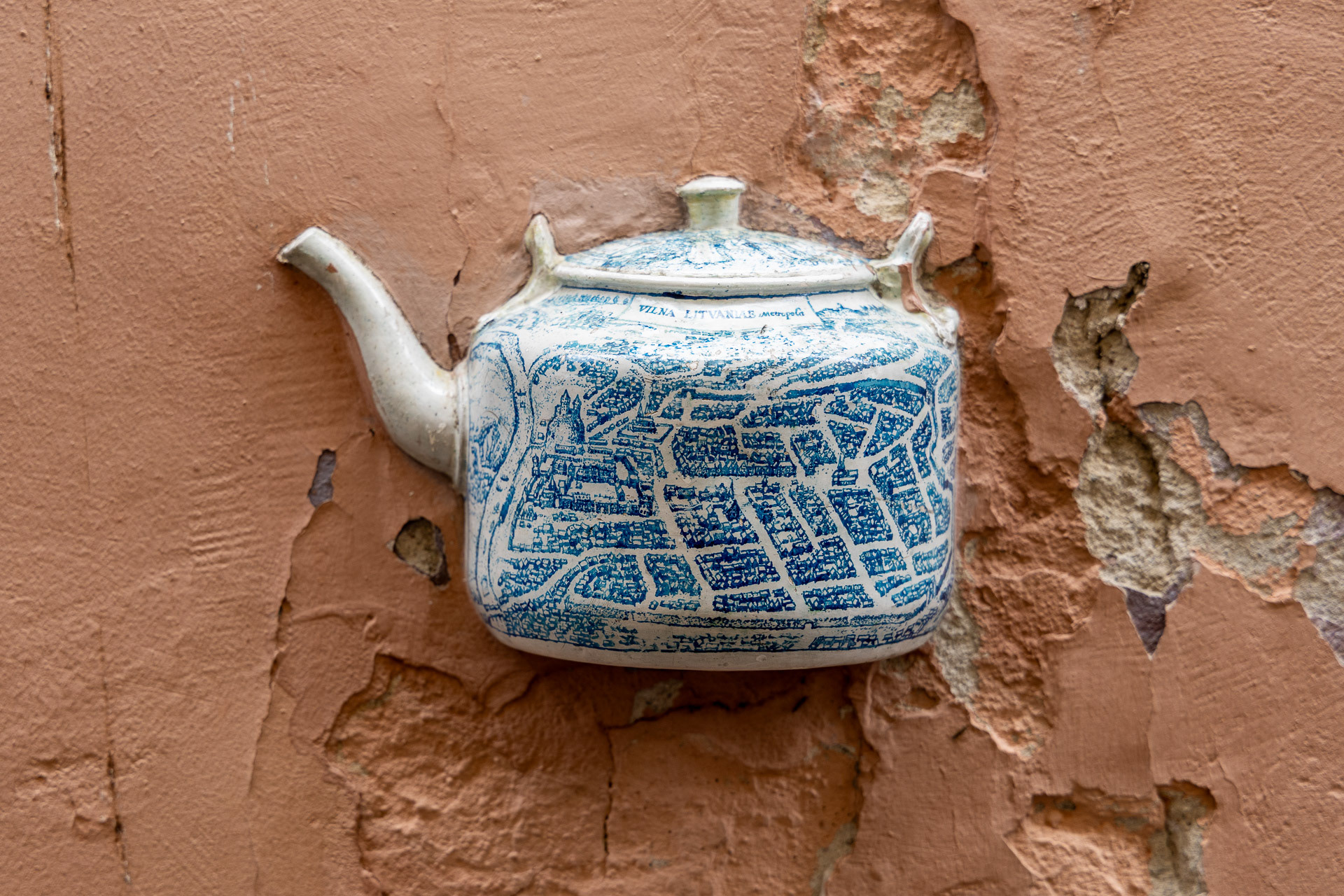 Vilnius - Art urbain faisant partie d'un ensemble de théières incrustées dans le mur. Elle est décorée d'une carte bleue de la vieille ville.