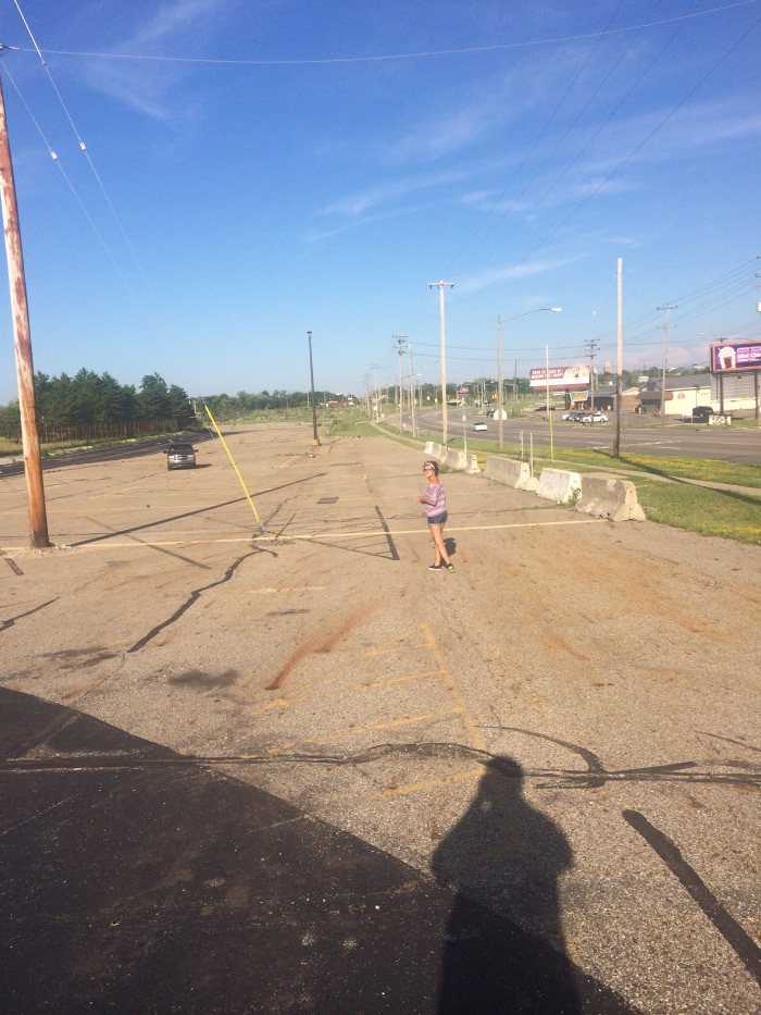 The design team explores the parking lot of the Lansing Metal Center.