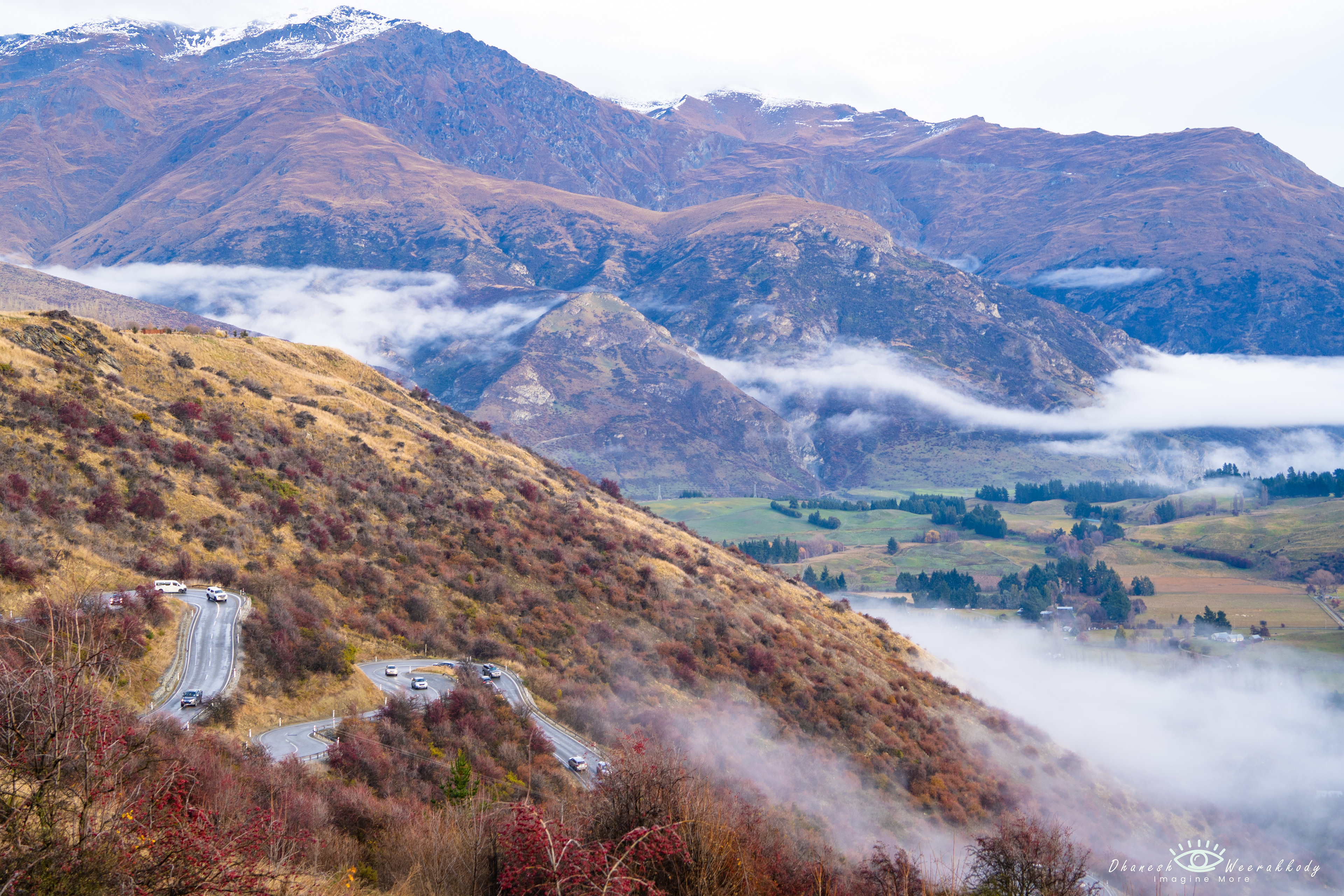 Scenic Landscape –Queenstown to Wanaka (June 2023)  Captured at the start of winter, this stunning view from Queenstown to Wanaka showcases snow-dusted mountains, lush green valleys, and winding roads leading through the picturesque town below. A perfect blend of nature’s beauty and alpine charm in New Zealand’s South Island.