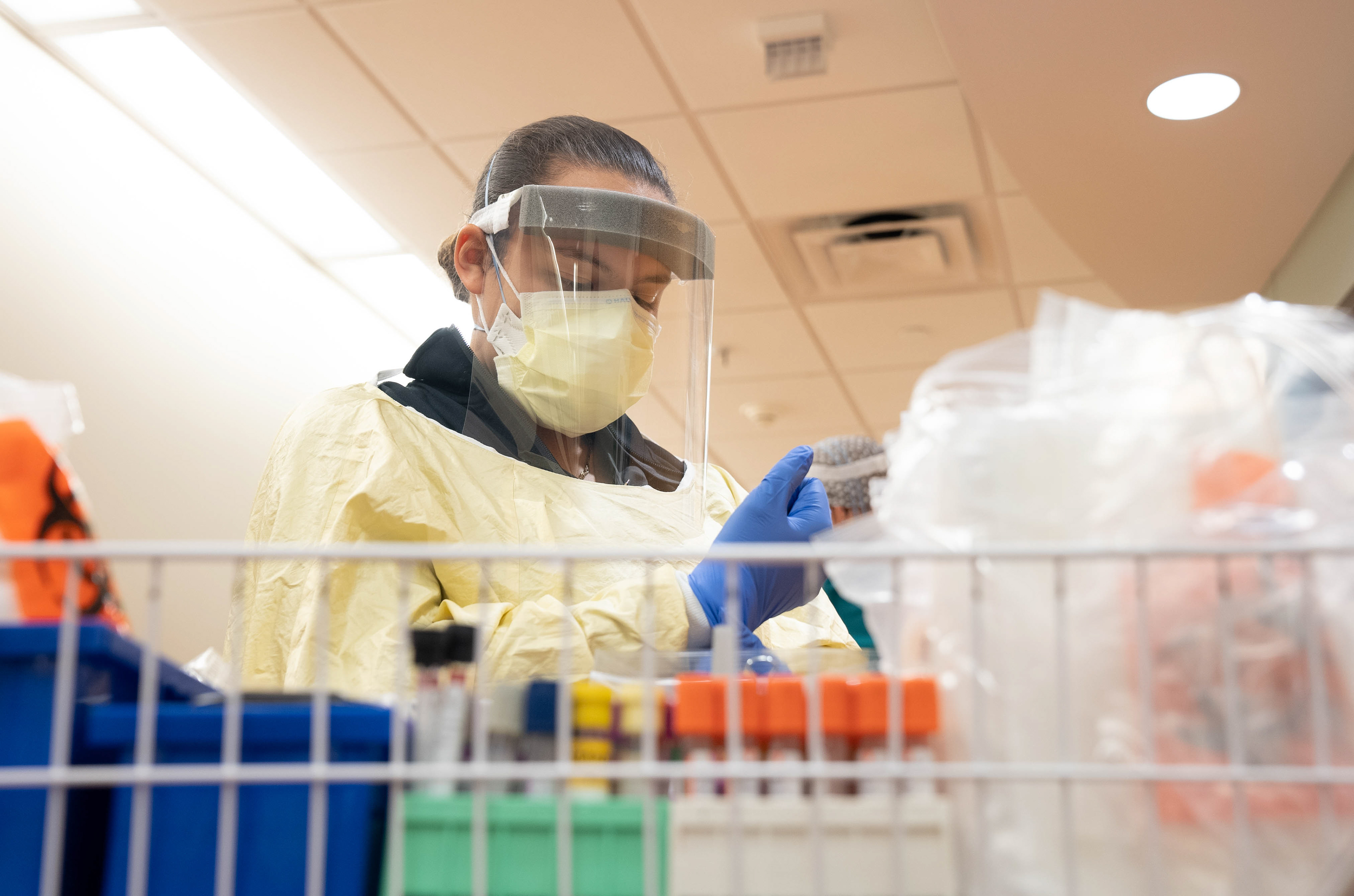 A Healthcare worker at Sparrow Hospital prepares to enter a patients room in the Covid Ward