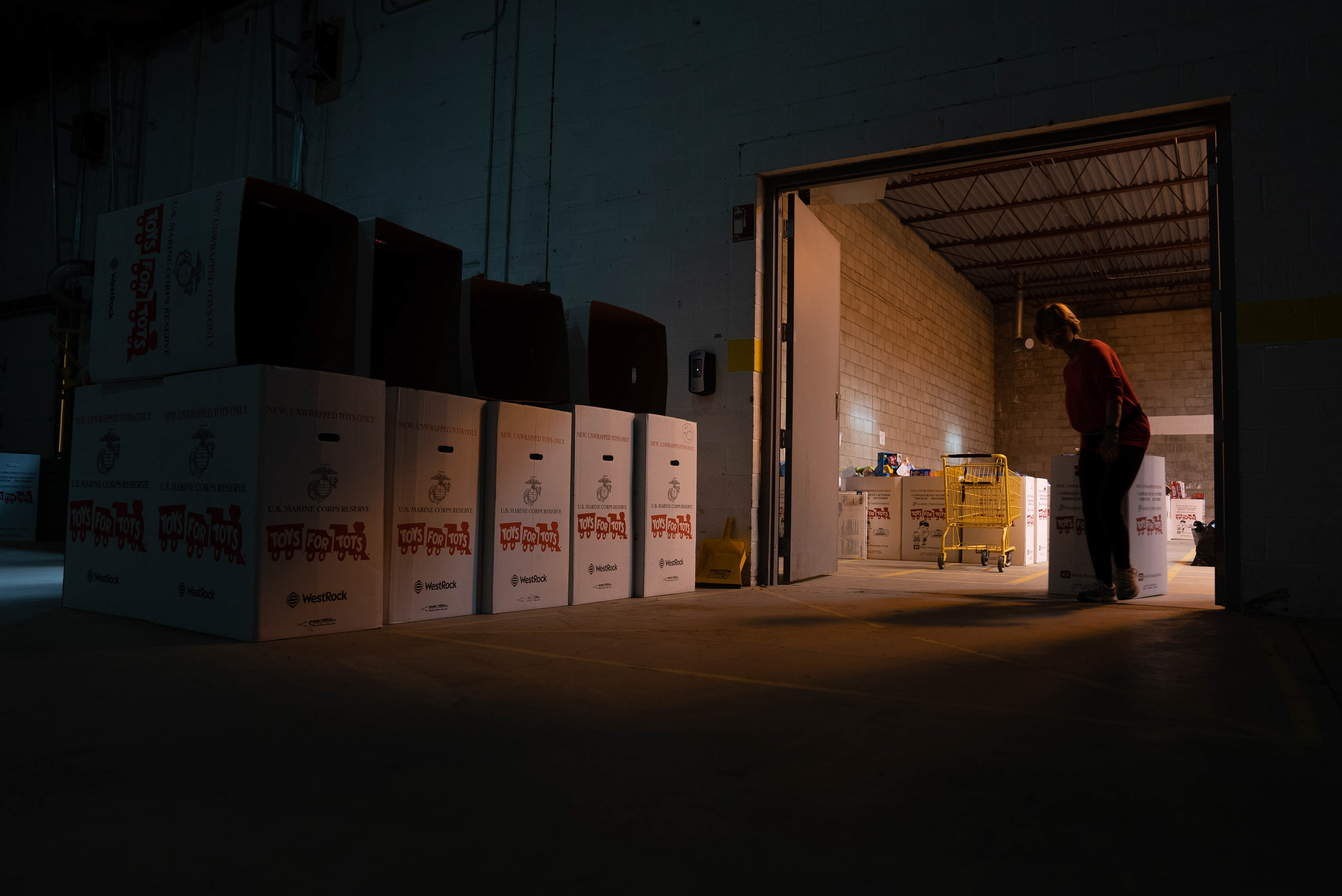 A Toys for Tots volunteer helps sort toys into boxes. Dec 07, 2021 