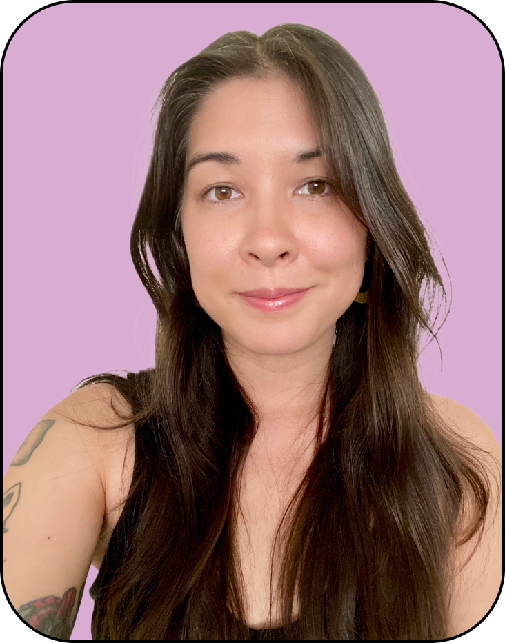 A woman with long dark hair and a sleeveless black top smiles in front of a purple background.