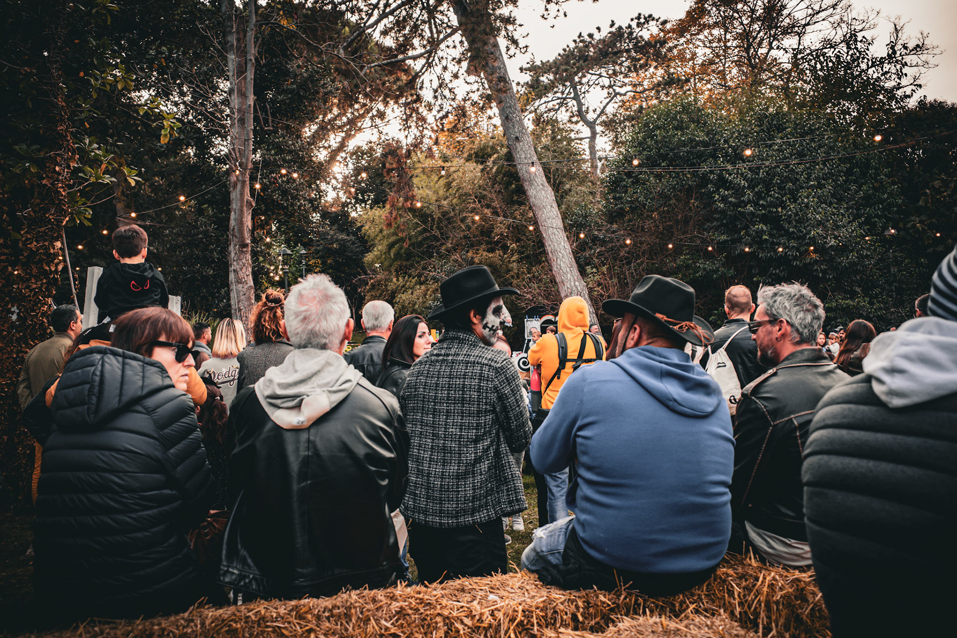 In the dusk of the living, a man with a painted face waits for the night to recognize him