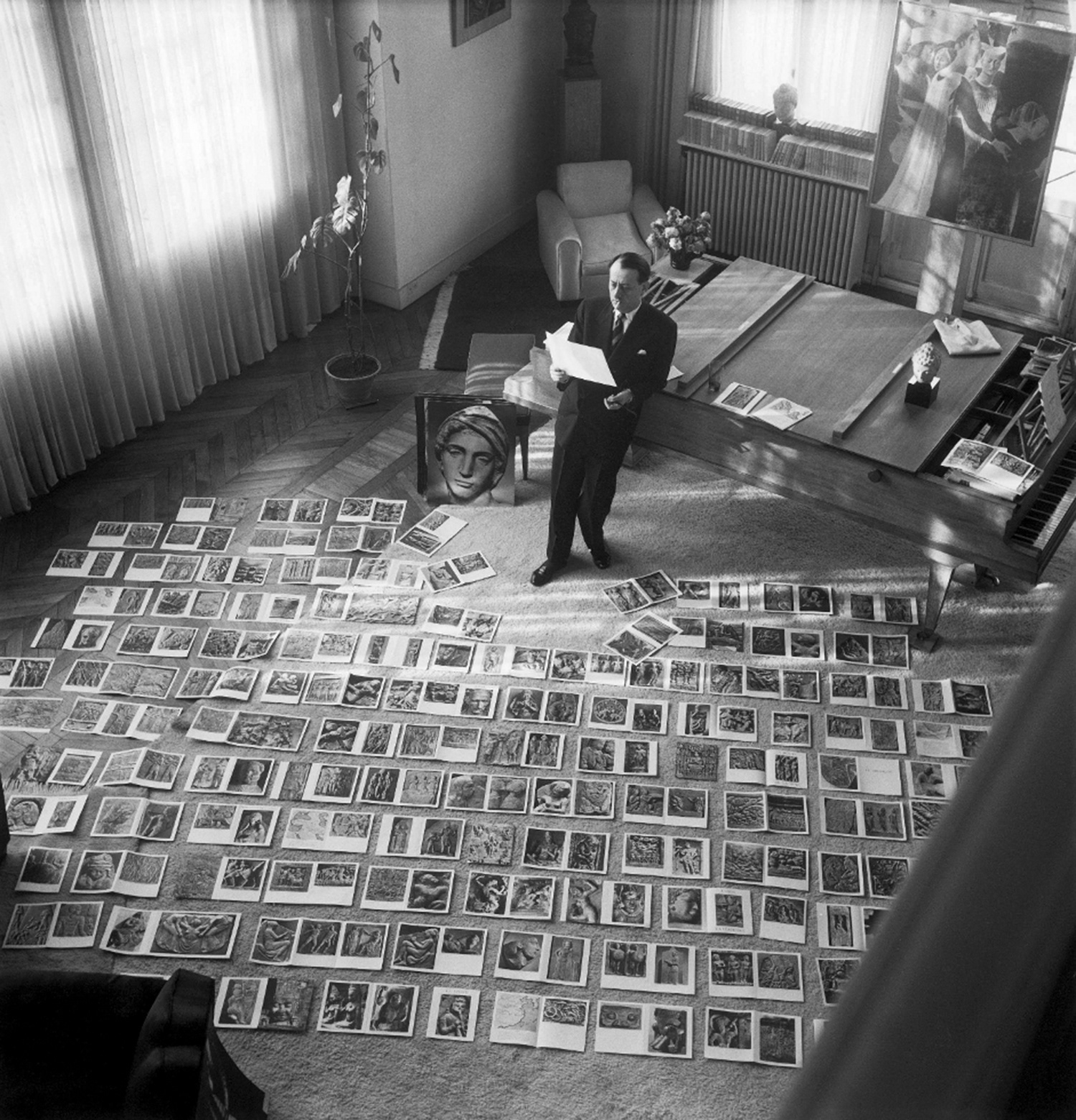 André Malraux selects photographs for Le Musée Imaginaire de la Sculpture Mondiale, 1947, © Getty Image