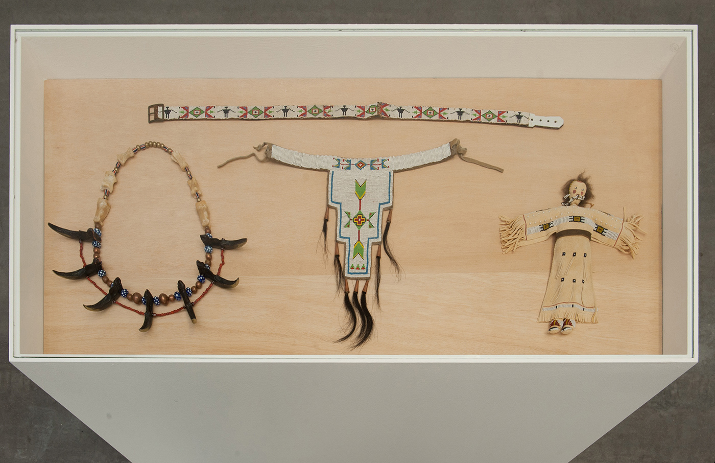 Fig 10: loincloth, belt, doll, necklace