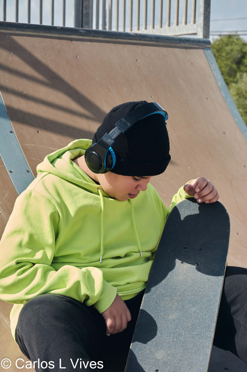 young teenager, with a skateboard, reflective on a rink, skating,