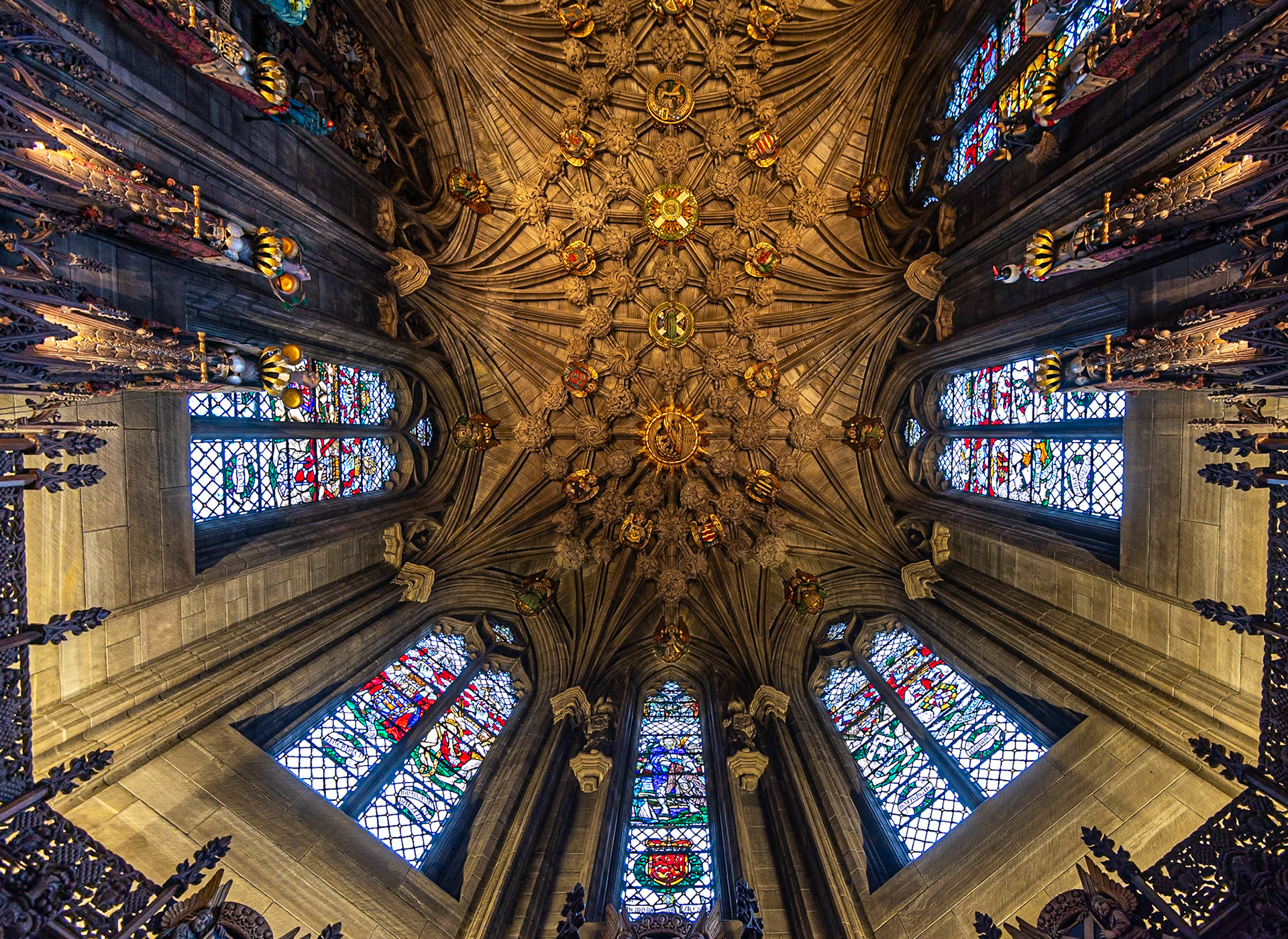Stone walls, colorful stainglass windows, ceiling carvings, and the spires and crest tips.