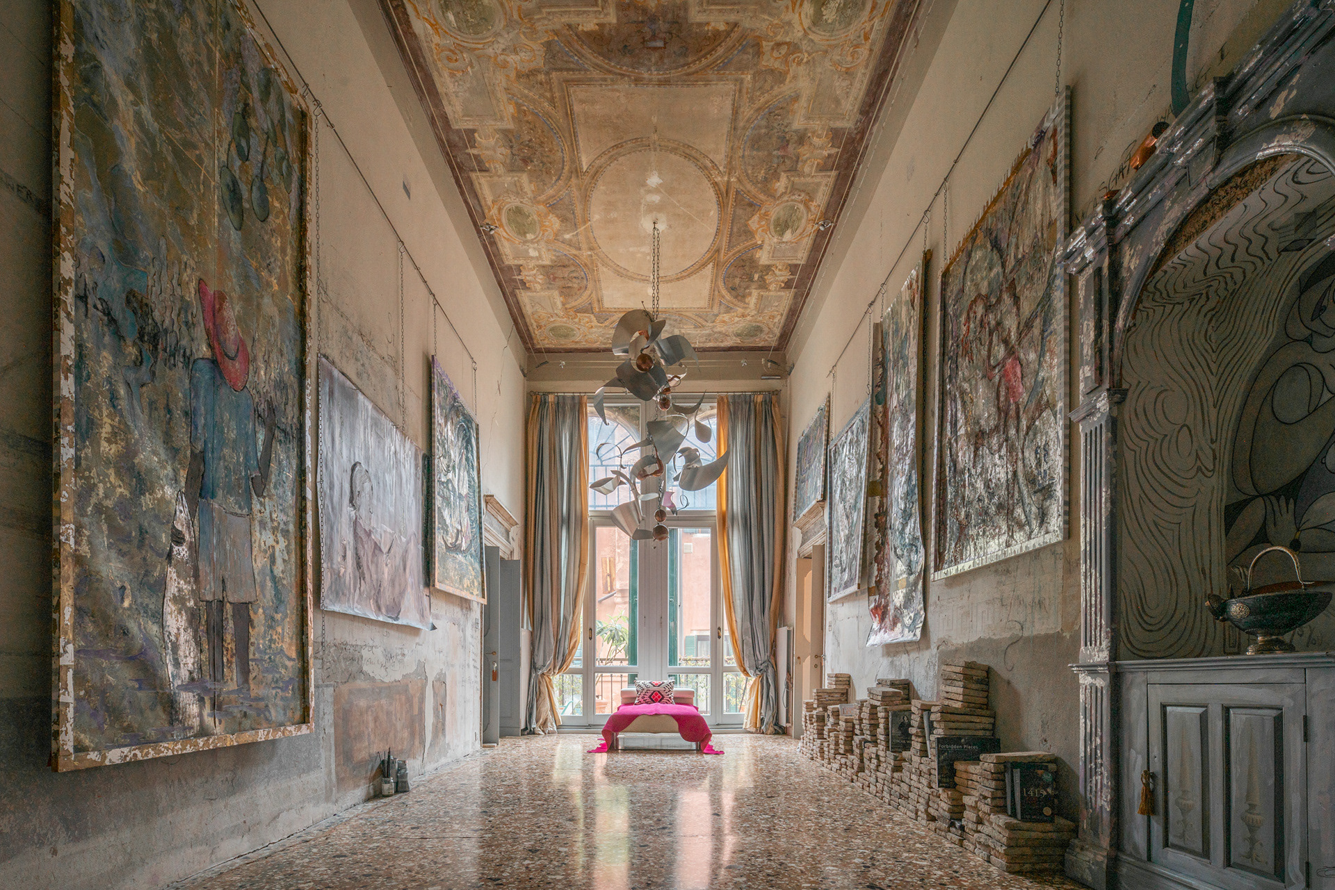  Image Title: "Harmony of Light at Palazzo Serenissima"  In this captivating image, Joan Porcel captures the essence of a Venetian interior with his mastery in the use of light. The scene unfolds within Palazzo Serenissima, an architectural gem that seamlessly blends with the unique atmosphere of Venice.  Natural light filters through the classic Venetian windows, creating an ethereal play of shadows and reflections on the exquisite marble floor. The soft golden light caresses the whitewashed walls, revealing intricate architectural details and vintage ornaments.  Carefully selected furniture, harmonizing with the classic style of the environment, reflects light delicately, adding a note of timeless elegance. A richly woven Persian carpet contributes to creating a focal point, further enriching the visual composition.  In the corner of the room, a vintage lamp diffuses soft light, adding a touch of intimacy and creating a suggestive atmosphere of calm and sophistication.  Joan Porcel captures this magical scene with a balanced composition and a keen eye for details. His ability to play with light tones creates an image that conveys the warm atmosphere of an authentic Venetian residence, unveiling its timeless beauty through the lens. In questa suggestiva immagine, Joan Porcel cattura l'essenza di un'interno veneziano con la sua maestria nell'utilizzo della luce. La scena si svolge all'interno di Palazzo Serenissima, un gioiello architettonico che si fonde elegantemente con l'atmosfera unica di Venezia.  La luce naturale filtra attraverso le classiche finestre veneziane, creando un gioco etereo di ombre e riflessi sul pavimento in marmo pregiato. La morbida luce dorata accarezza le pareti imbiancate, rivelando dettagli architettonici intricati e ornamenti d'epoca.  I mobili, selezionati con cura per armonizzarsi con lo stile classico dell'ambiente, riflettono la luce in modo delicato, aggiungendo una nota di eleganza senza tempo. Un tappeto persiano riccamente intessuto contribuisce a creare un punto focale, arricchendo ulteriormente la composizione visiva.  Nell'angolo della stanza, una lampada d'epoca diffonde una luce soffusa, aggiungendo un tocco di intimità e creando una suggestiva atmosfera di calma e raffinatezza.  Joan Porcel cattura questo scenario magico con una composizione equilibrata e un occhio attento per i dettagli. La sua abilità nel giocare con le tonalità di luce crea un'immagine che trasmette la calda atmosfera di un'autentica dimora veneziana, svelando la sua bellezza senza tempo attraverso l'obiettivo.