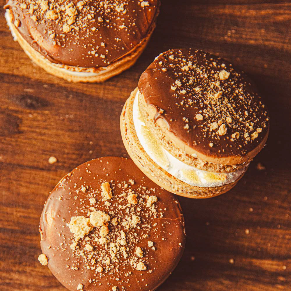 Summertime S'mores Macarons: Cocoa Shells with a Toasted Swiss Meringue & Semisweet Chocolate Ganache, topped with Semisweet Chocolate and Graham Cracker Crumbs