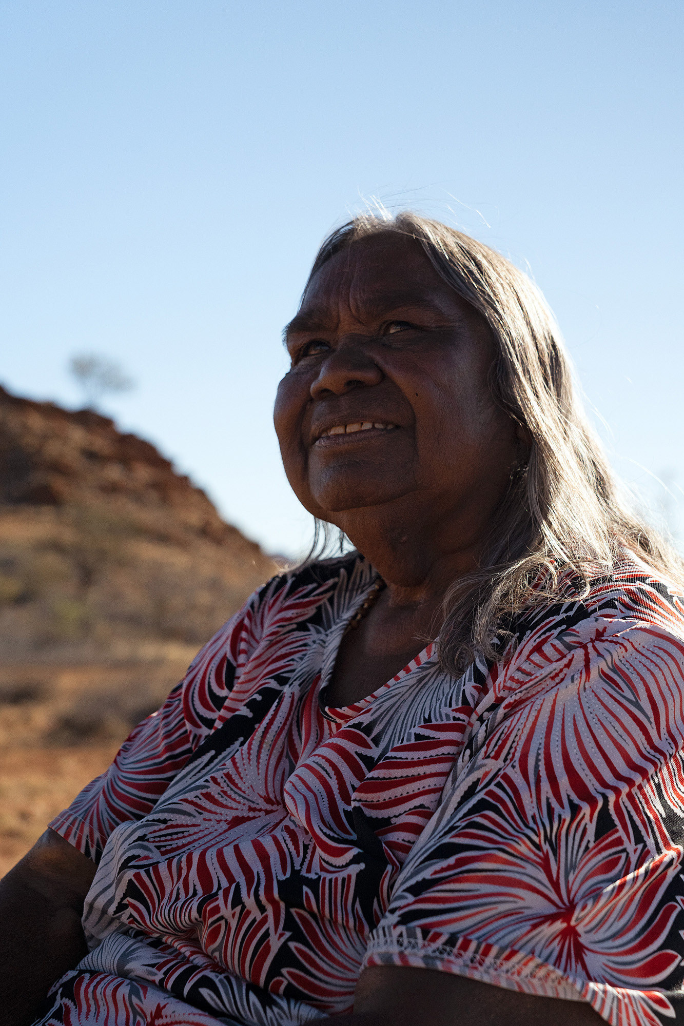 Kathleen Kemarre Wallace, an Eastern Arrernte woman, born in the Central Australian bush, and raised at Santa Teresa Mission from age 13. While at the mission, she was told to give her stories away, to forget them. But she refused and has kept them strong all her life.