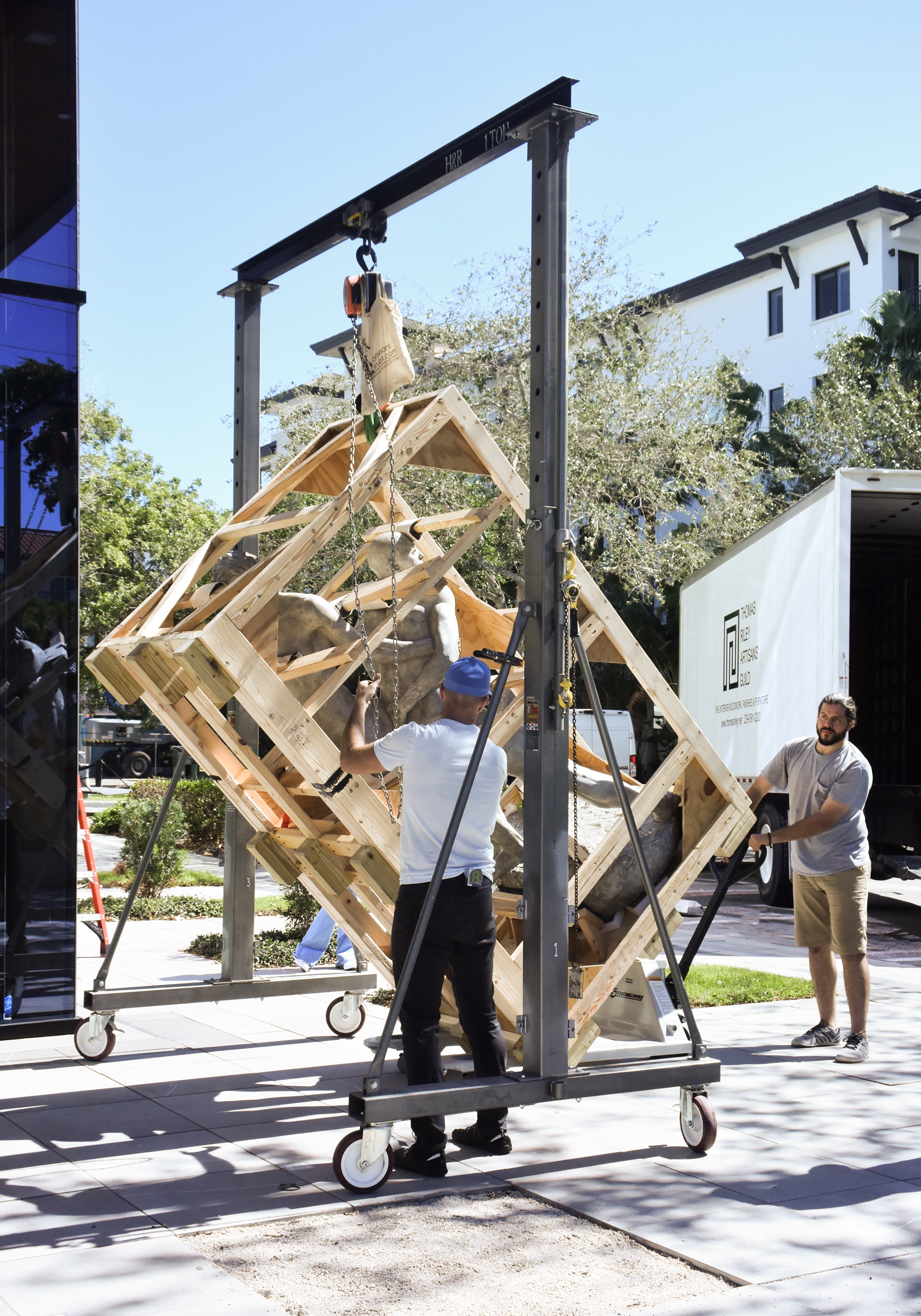 Art rigging utilizing H&R Studio gantry crane to upend a large sculpture crate