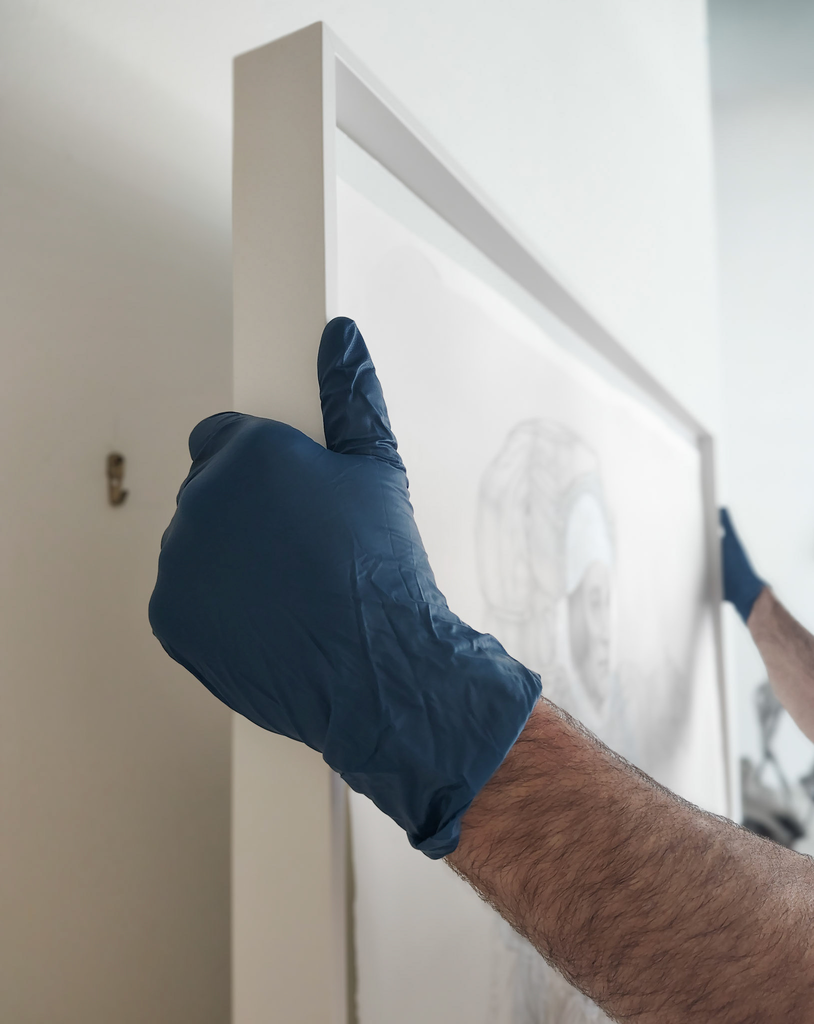 Hanging framed work on D-rings and German hangers