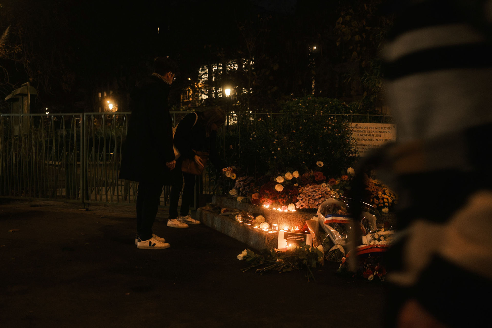 People placing flowers next to the commemorative plaque in honor of the victims of La Bonne Biere &amp; Casa Nostra, two of the brasseries that were attacked during the terrorist attacks in Paris, on November 13th 2015. Paris, France, 13th of November 2025. By Maria Kalafatsi