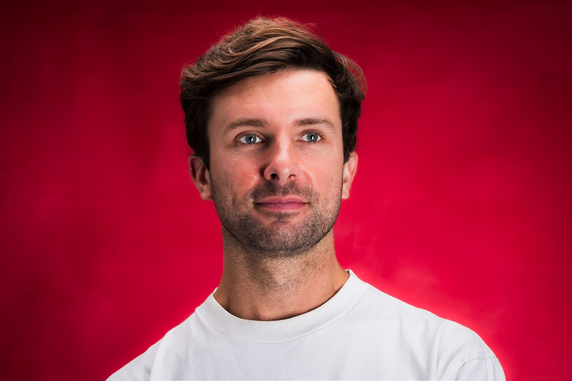 Ben in studio lights portrait, indoors, 3 lights, landscape portrait, red background, white shirt, Speos studio, Paris, France, April 24th 2025, ©MariaKALAFATSI