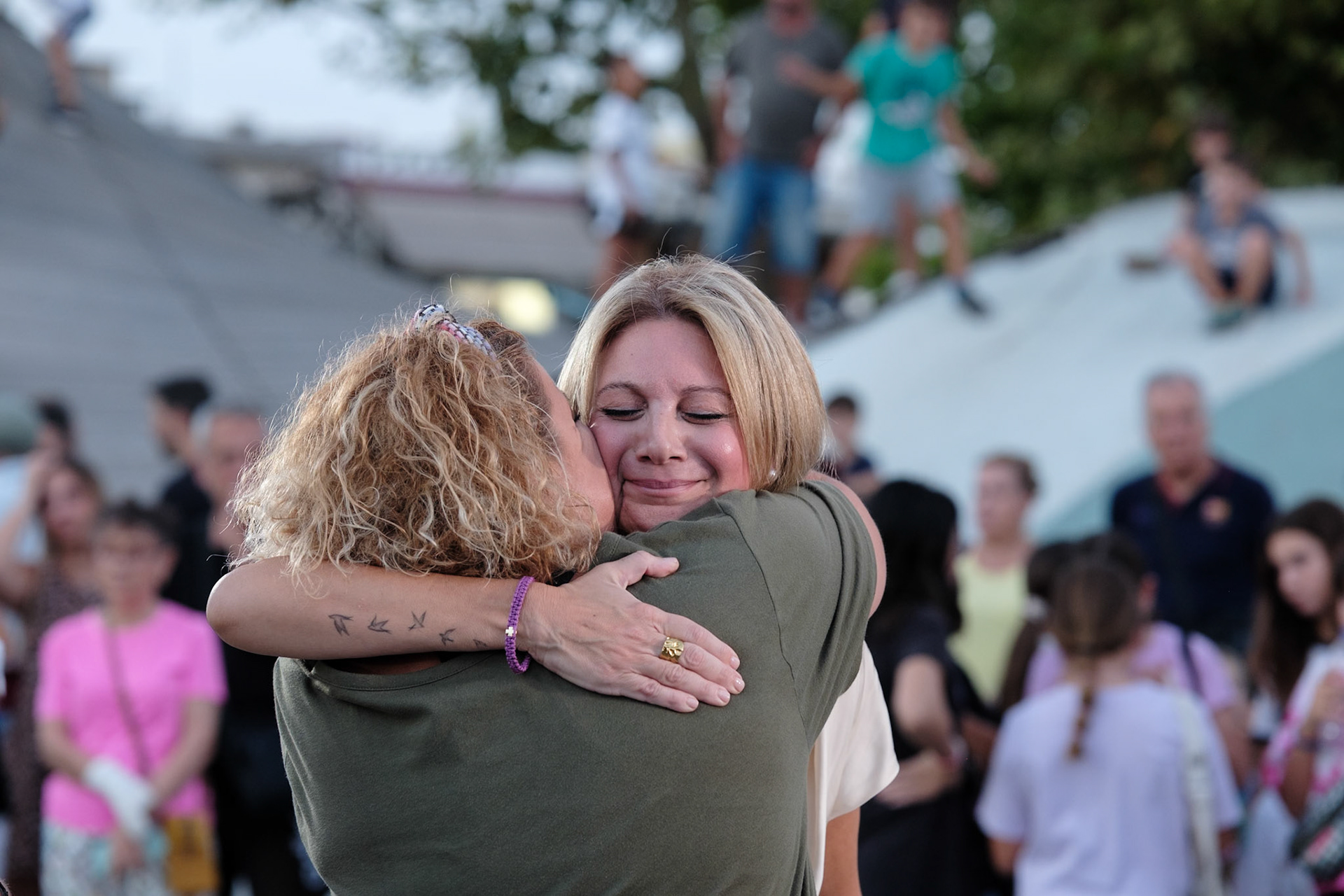 Local embracing Maria Karistianou before the start of the event dedicated to the victims of the train wreckage of Tempi 2023. Organised by local ngo Kialli of Thermi & supported by the local community. Thermi, Thessaloniki, Greece, 10.09.2025 by Maria Kalafatsi